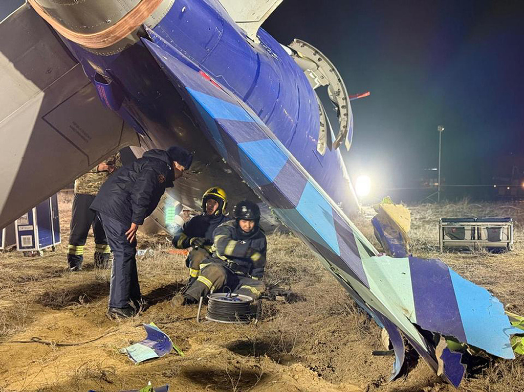 In this photo released by Kazakhstan's Emergency Ministry Press Service, rescuers work at the wreckage of Azerbaijan Airlines Embraer 190 lies on the ground near the airport of Aktau, Kazakhstan, Thursday, Dec. 26, 2024. (Kazakhstan's Emergency Ministry Press Service via AP)