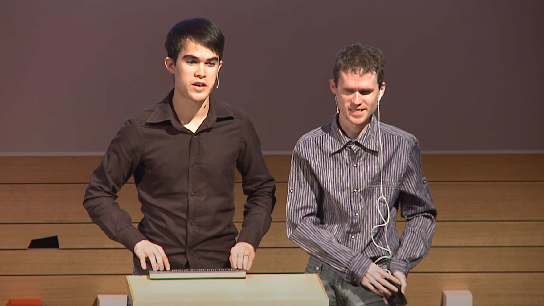 Jamie Teh and his childhood friend Michael Curren are on stage speaking at a TEDx talk in 2014 about their free text-to-speech software NVDA.