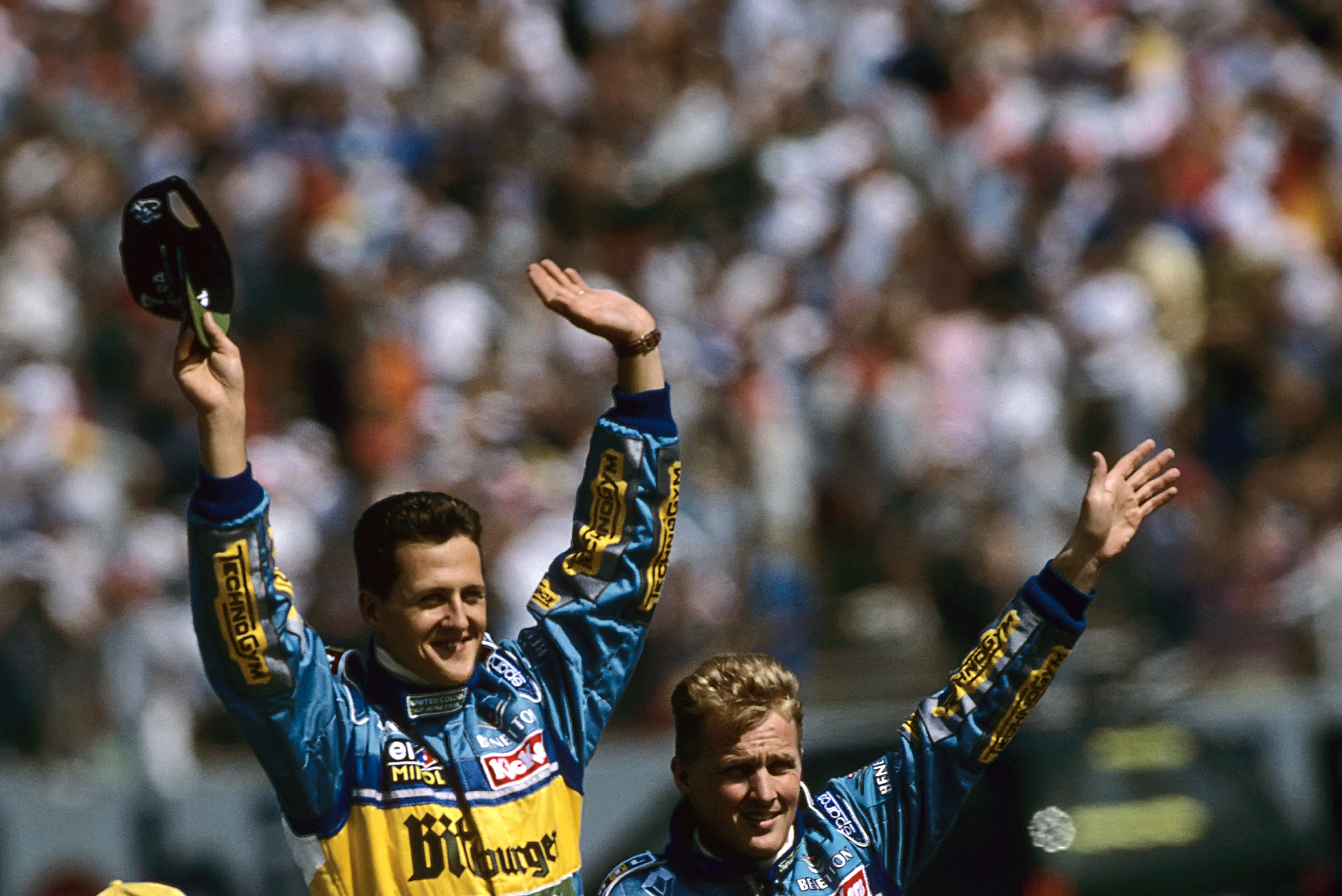Michael Schumacher, Johnny Herbert, Grand Prix of Germany, Hockenheimring, 30 July 1995. Michael Schumacher and teammate Johnny Herbert on a parade lap before the 1995 German Grand Prix. (Photo by Paul-Henri Cahier /Getty Images)