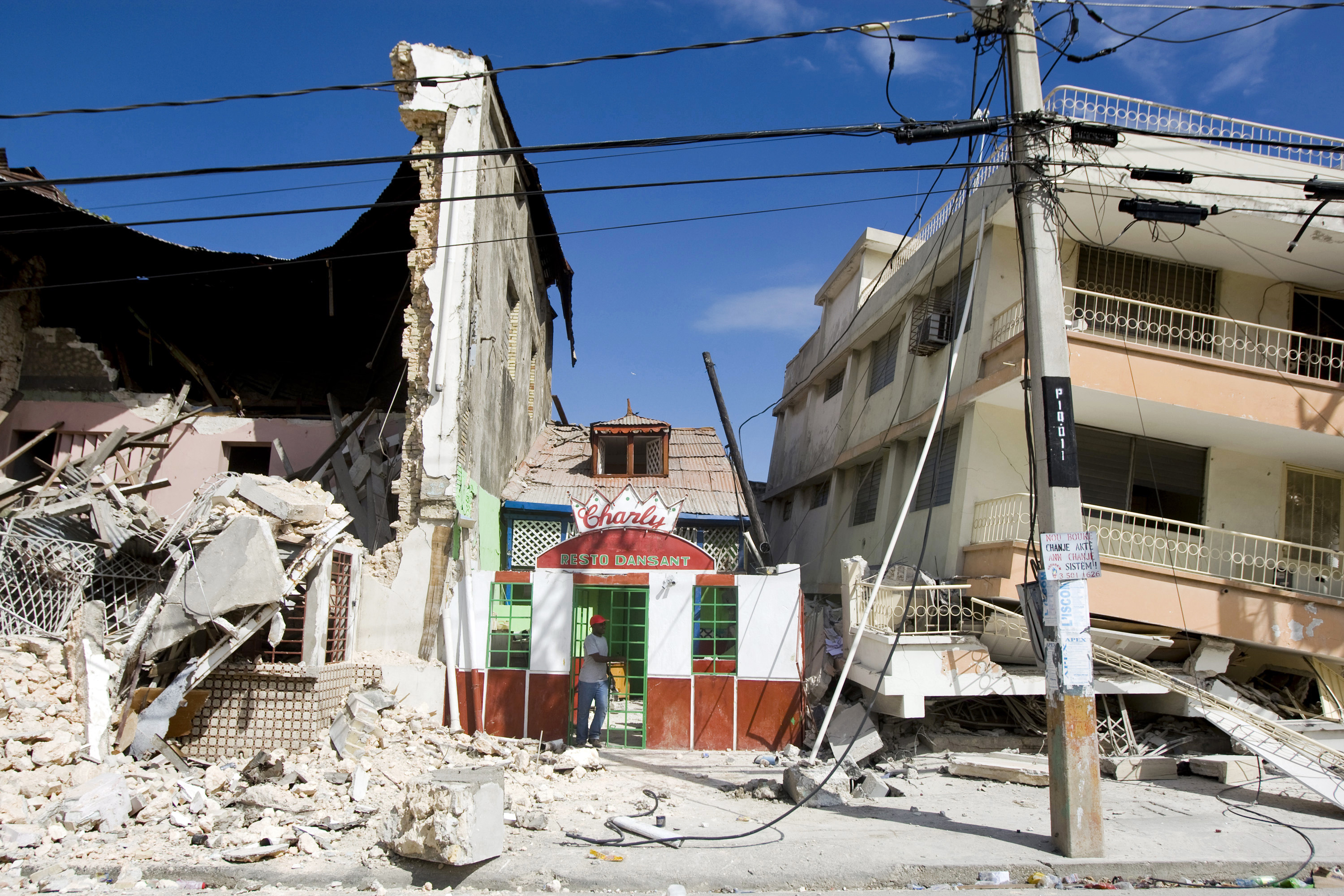 A man exits a restaurant after he looked for his belongings after the 2010 Haiti earthquake.