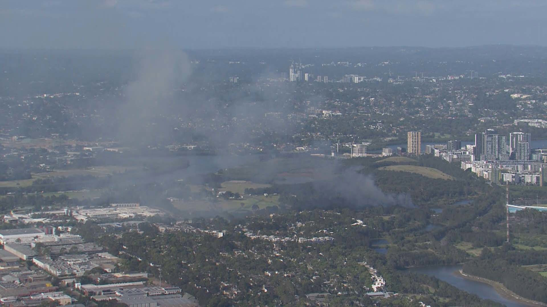 Fire crews are fighting a bushfire near Sydney Olympic Park in the city's west..