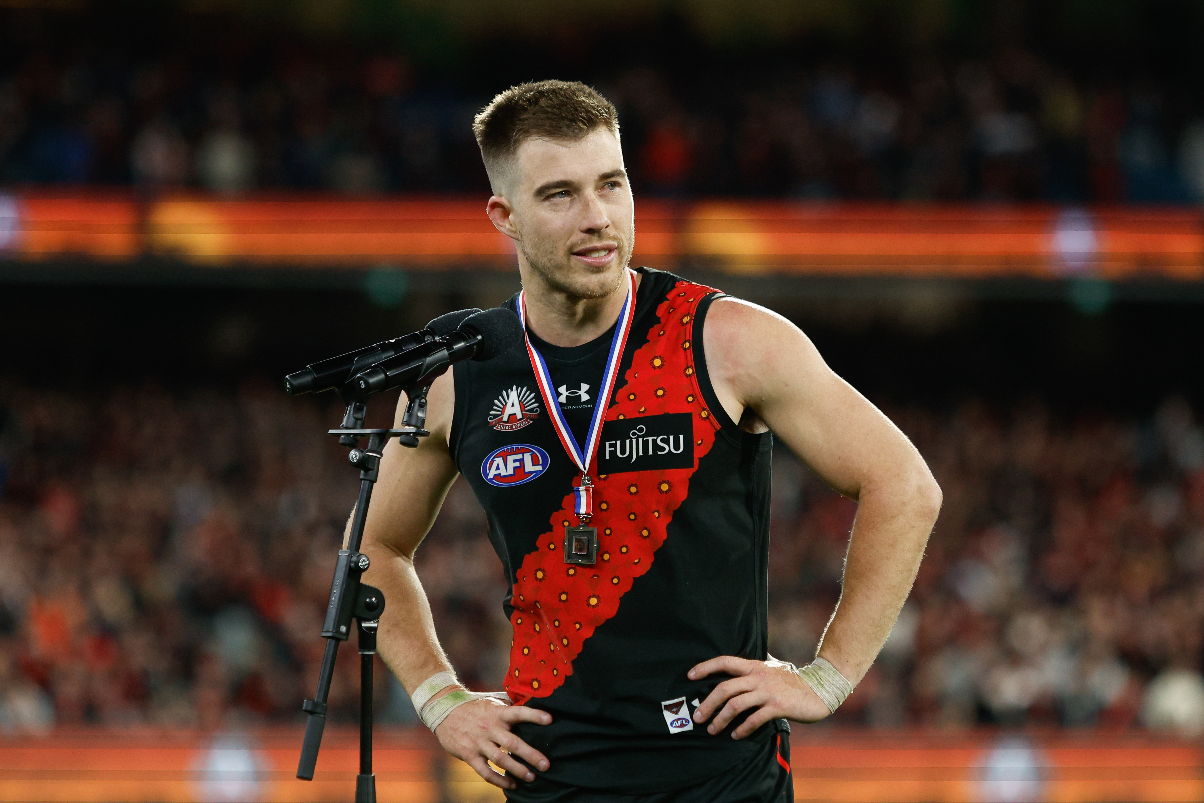 Zach Merrett of the Bombers receives the Anzac Day Medal.