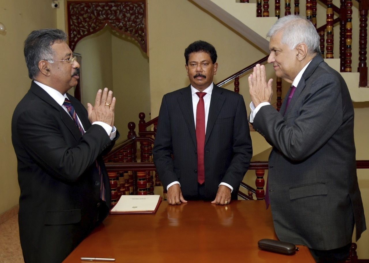 In this photograph provided by the Sri Lankan President's Office, interim President Ranil Wickremesinghe, right, greets Chief Justice Jayantha Jayasuriya during the oath-taking ceremony in Colombo, Sri Lanka, Friday, July 15, 2022. Prime Minister Wickremesinghe was sworn in as Sri Lanka's interim president Friday until Parliament elects a successor to Gotabaya Rajapaksa, who resigned after mass protests over the country's economic collapse forced him from office.  