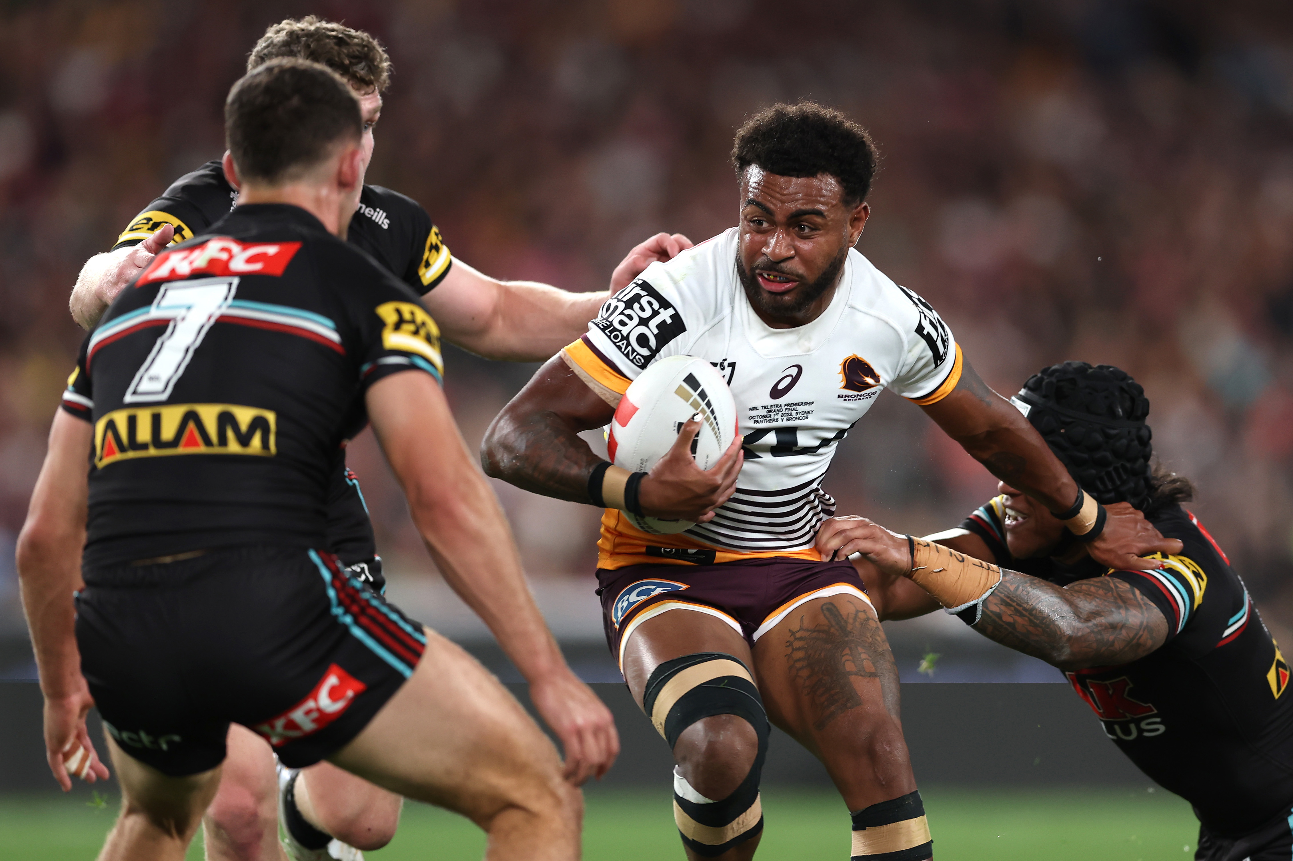Ezra Mam of the Broncos is tackled during the 2023 NRL grand final.