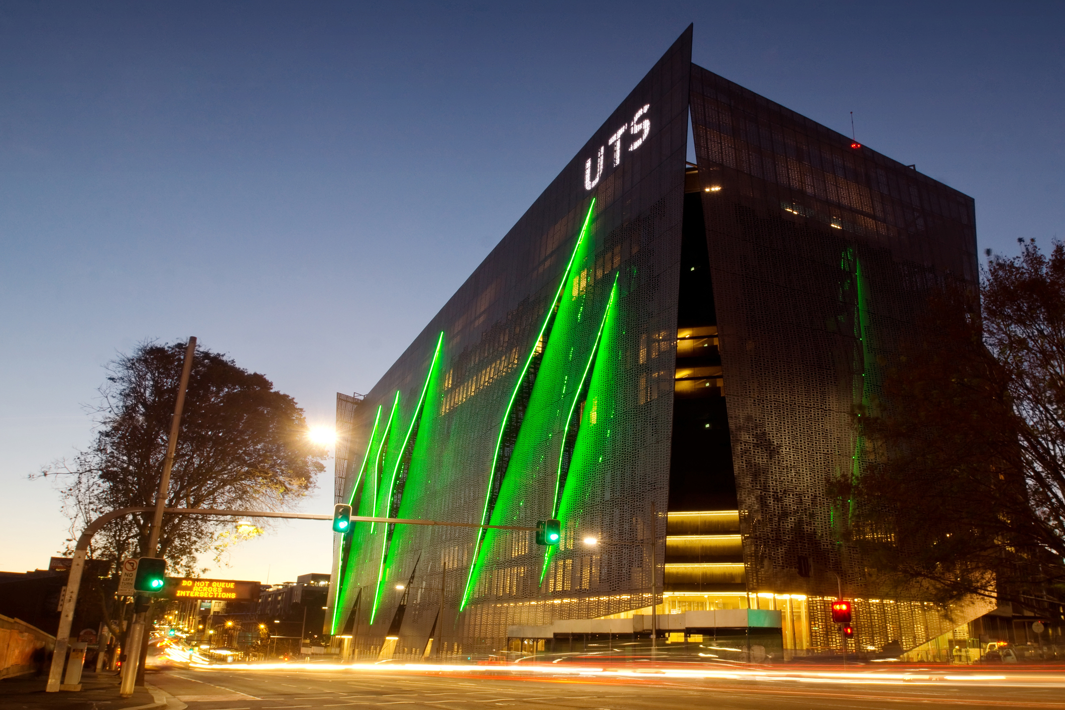 Sydney, Australia - May 8, 2014: Traffic moves past the University of Technology Sydney (UTS) at dusk. Pictured is the new Broadway/ITE  Building, which features a gill-like facade.