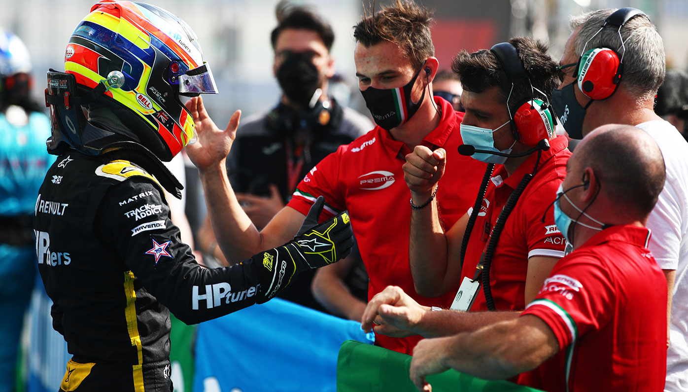 Oscar Piastri celebrates with his Prema Racing team after winning in Spain.