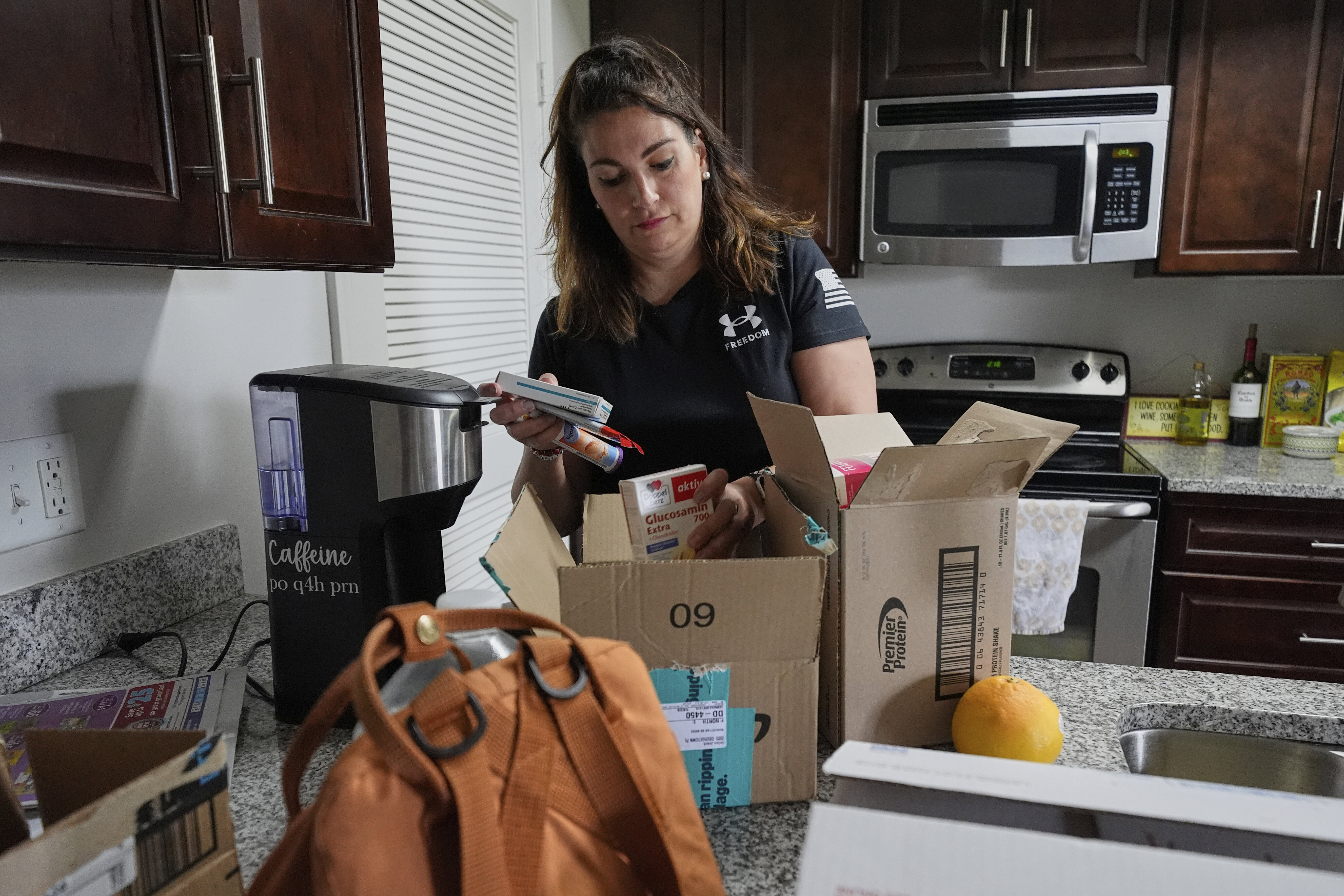 Shea Giagnorio packs belongings in her apartment days after getting fired from her job with the Administration for Children and Families, Monday, April 14, 2025, in Overland Park, Kan. (AP Photo/Charlie Riedel)