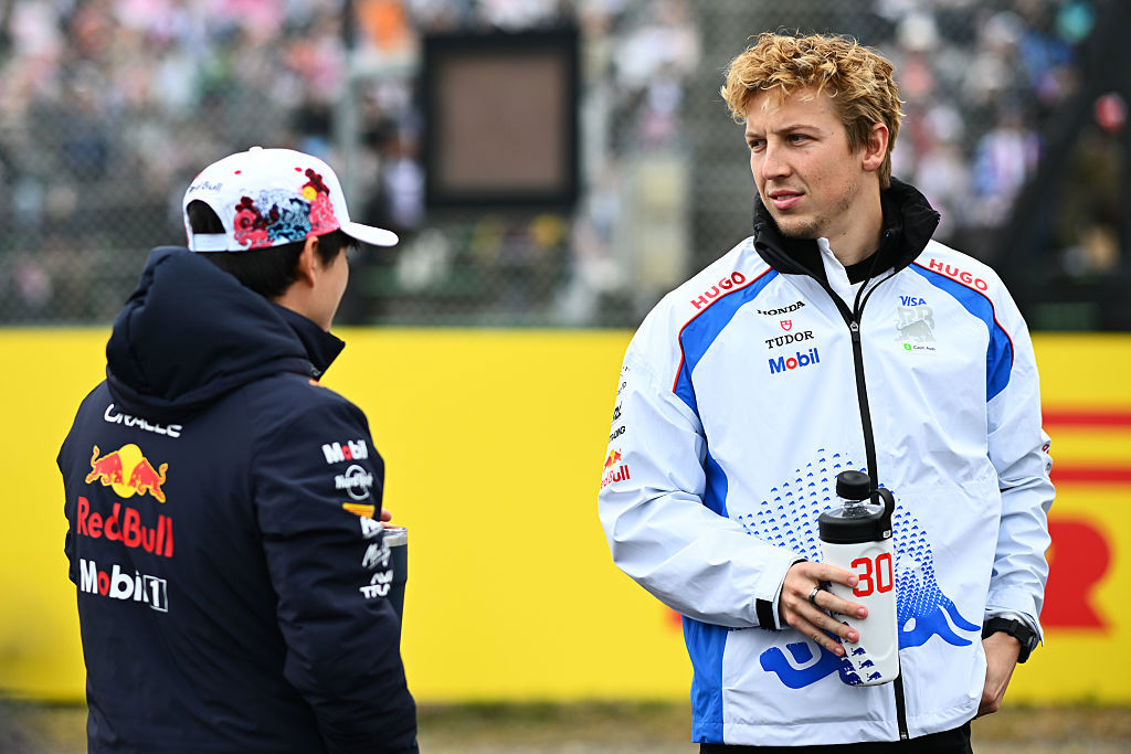 Yuki Tsunoda and Liam Lawson of New Zealand talk on the drivers parade prior to the F1 Grand Prix of Japan.