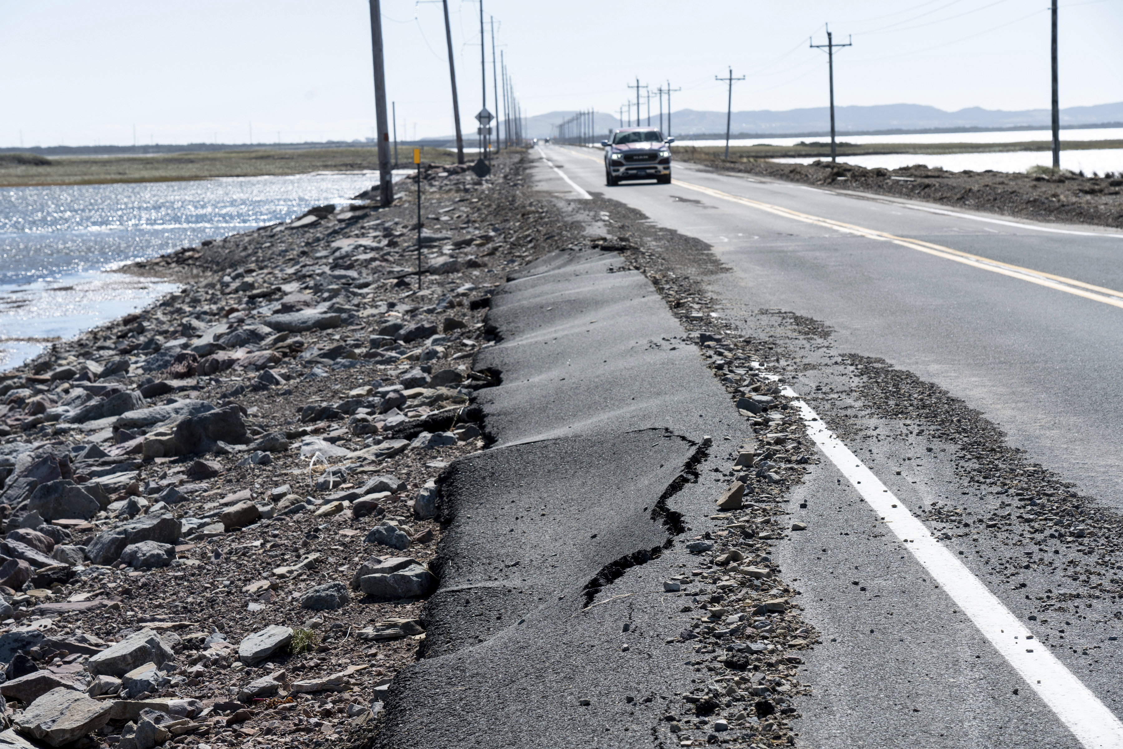 Road damage after Hurricane Fiona at Pointe-aux-Loups is seen on the Les Îles-de-la-Madeleine, Quebec, on Sunday, Sept. 25, 2022. (Nigel Quinn/The Canadian Press via AP)
