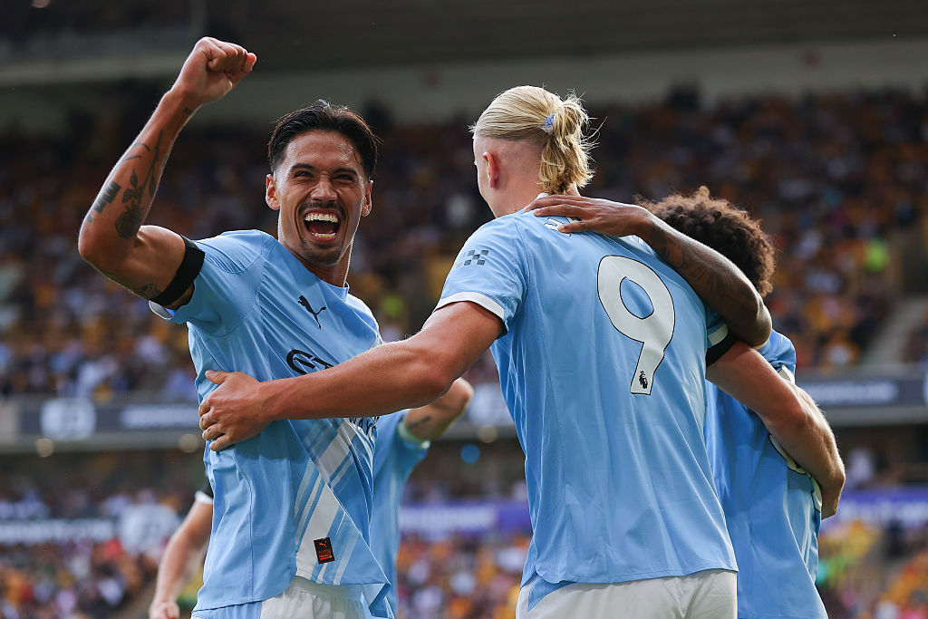 Erling Haaland of Manchester City celebrates with Tijjani Reijnders after scoring their side's third goal.