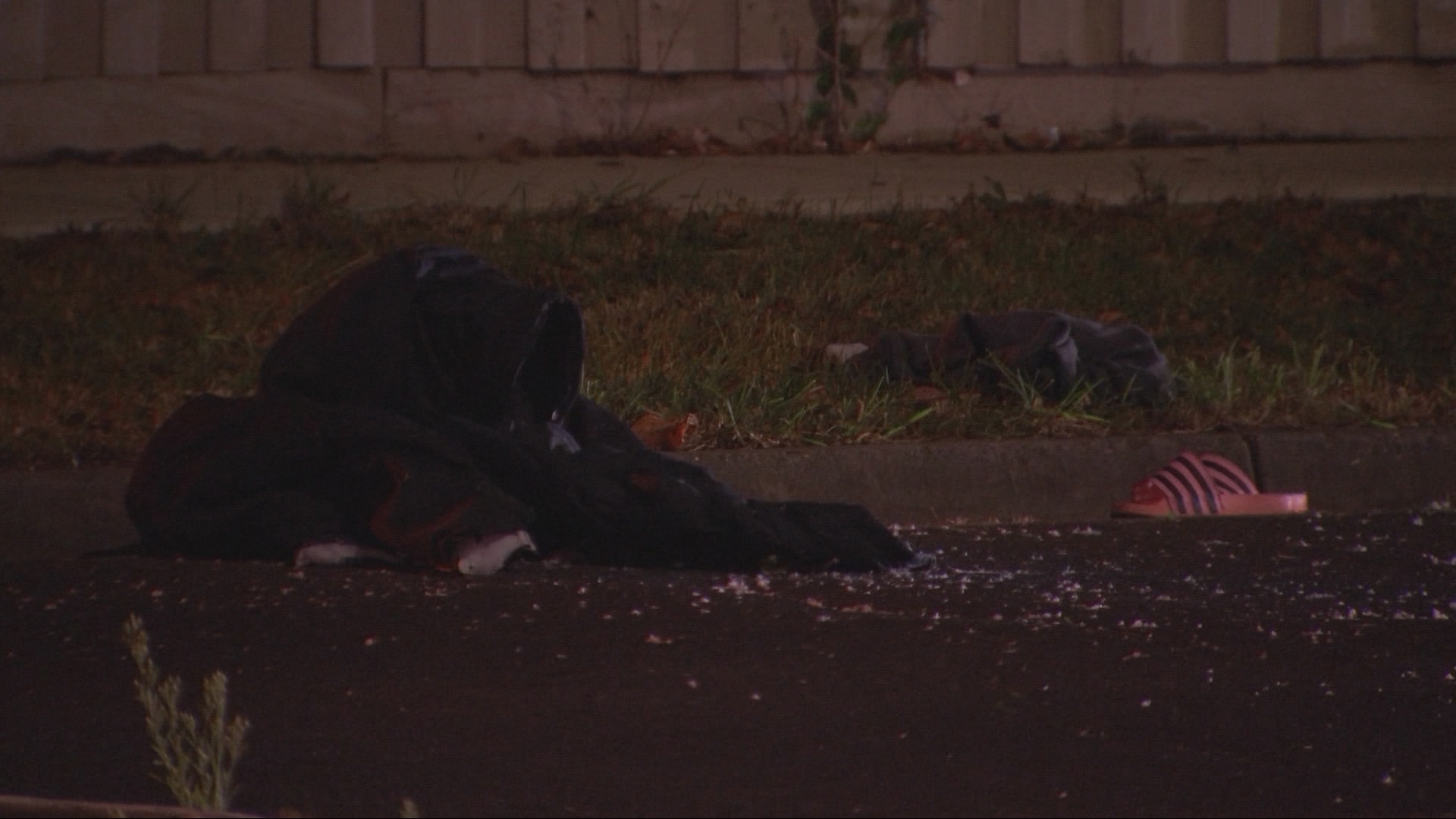 Broken shards of glass and items of clothing were left on the street.
