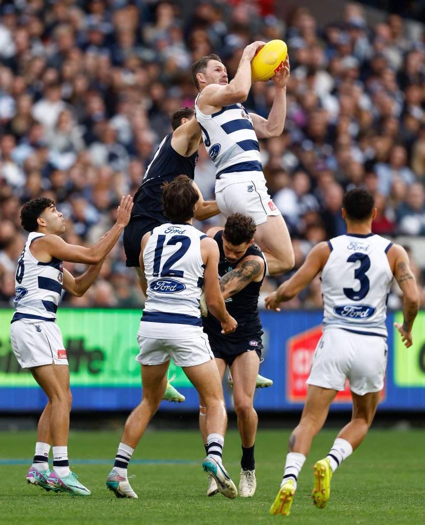 Patrick Dangerfield of the Cats takes a spectacular mark over Zac Williams of the Blues.