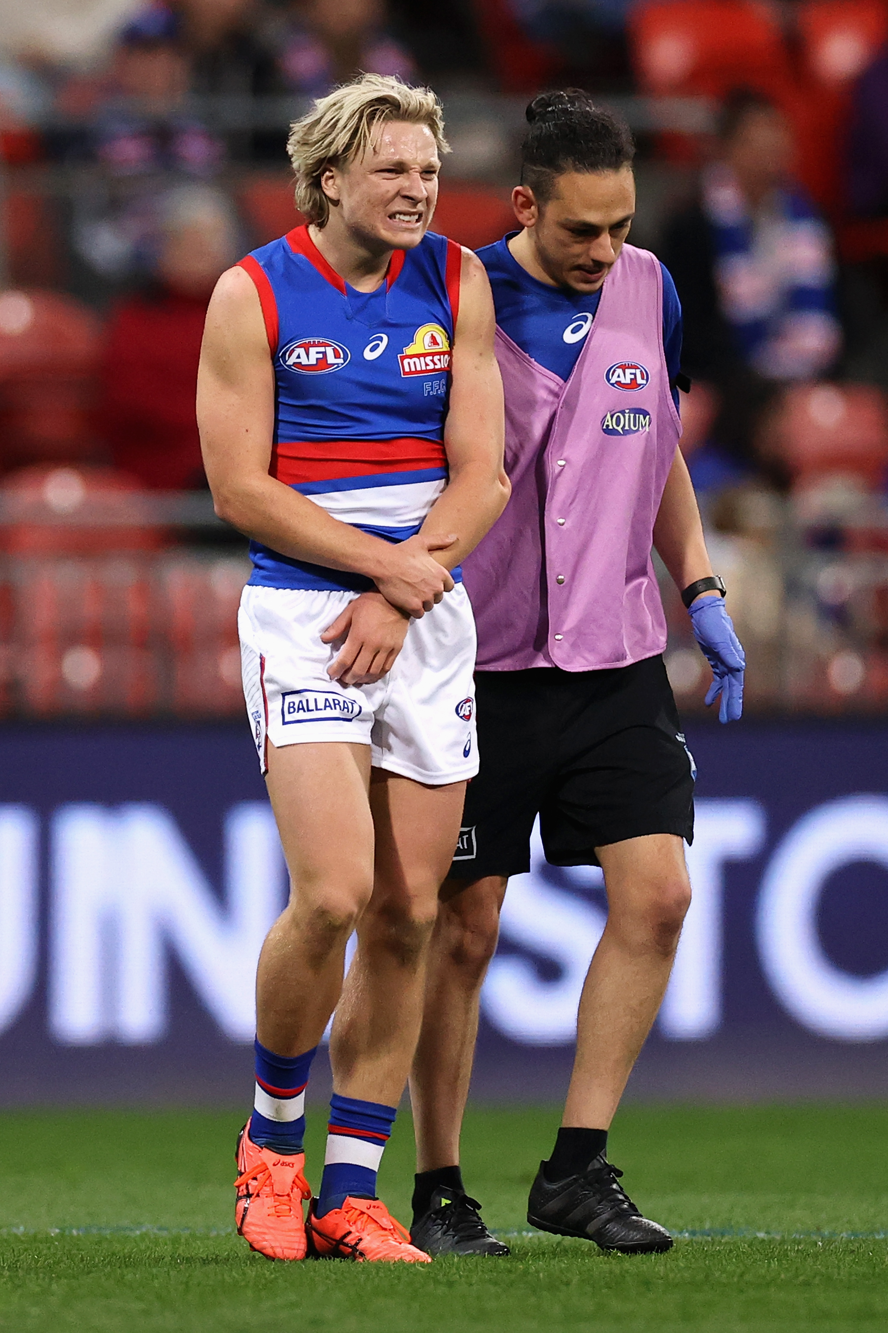 Cody Weightman of the Bulldogs leaves the field with a dislocated elbow duing the round 14 AFL match between the GWS Giants and the Western Bulldogs. Photo: Cameron Spencer