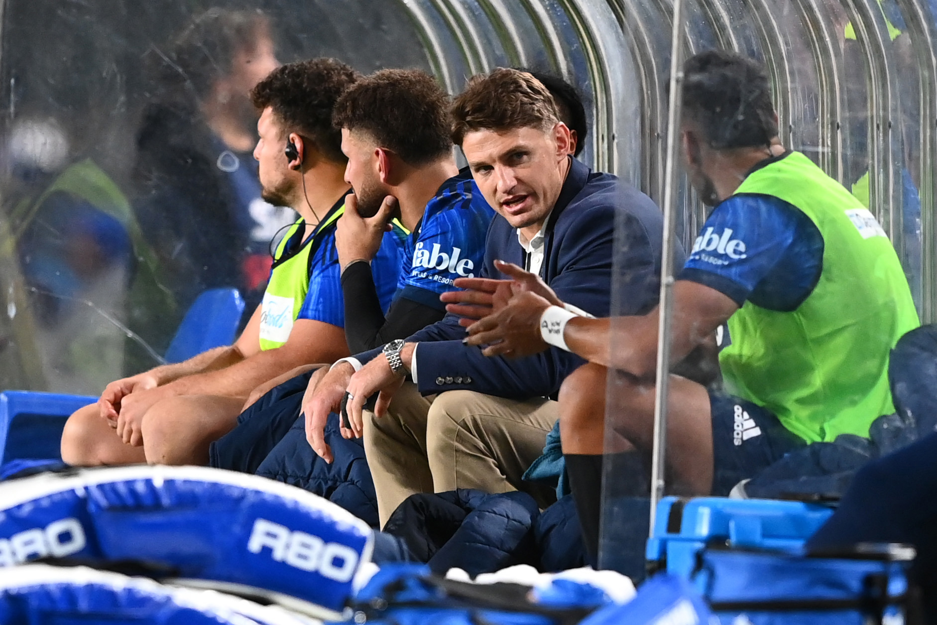 Injured Beauden Barrett sits ob the bench during the Super Rugby Pacific match between the Blues and Moana Pasifika at Eden Park.