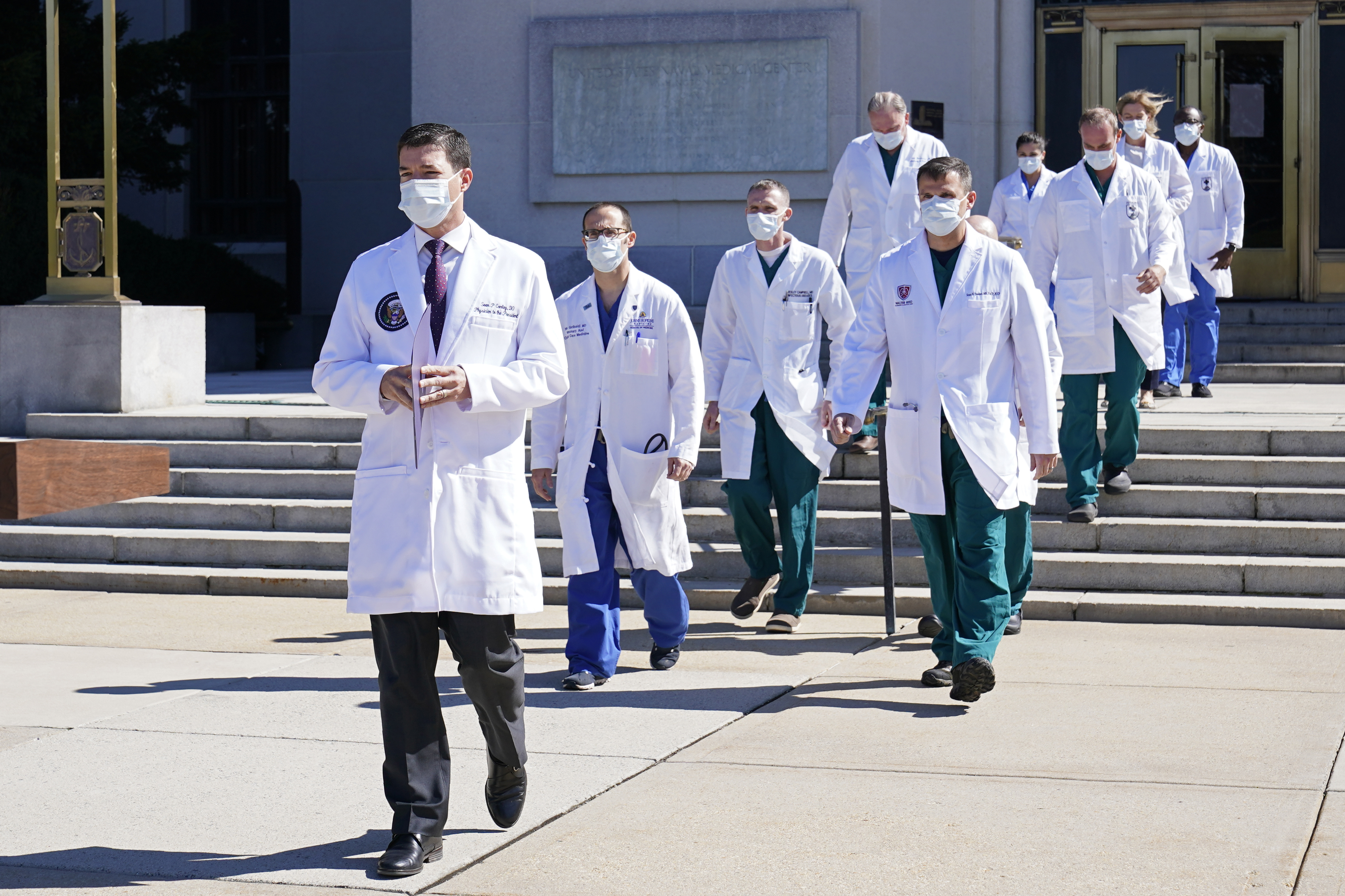 Dr Sean Conley, physician to President Donald Trump, is followed by a team of doctors for a briefing with reporters at Walter Reed National Military Medical Centre. (AP Photo/Susan Walsh)