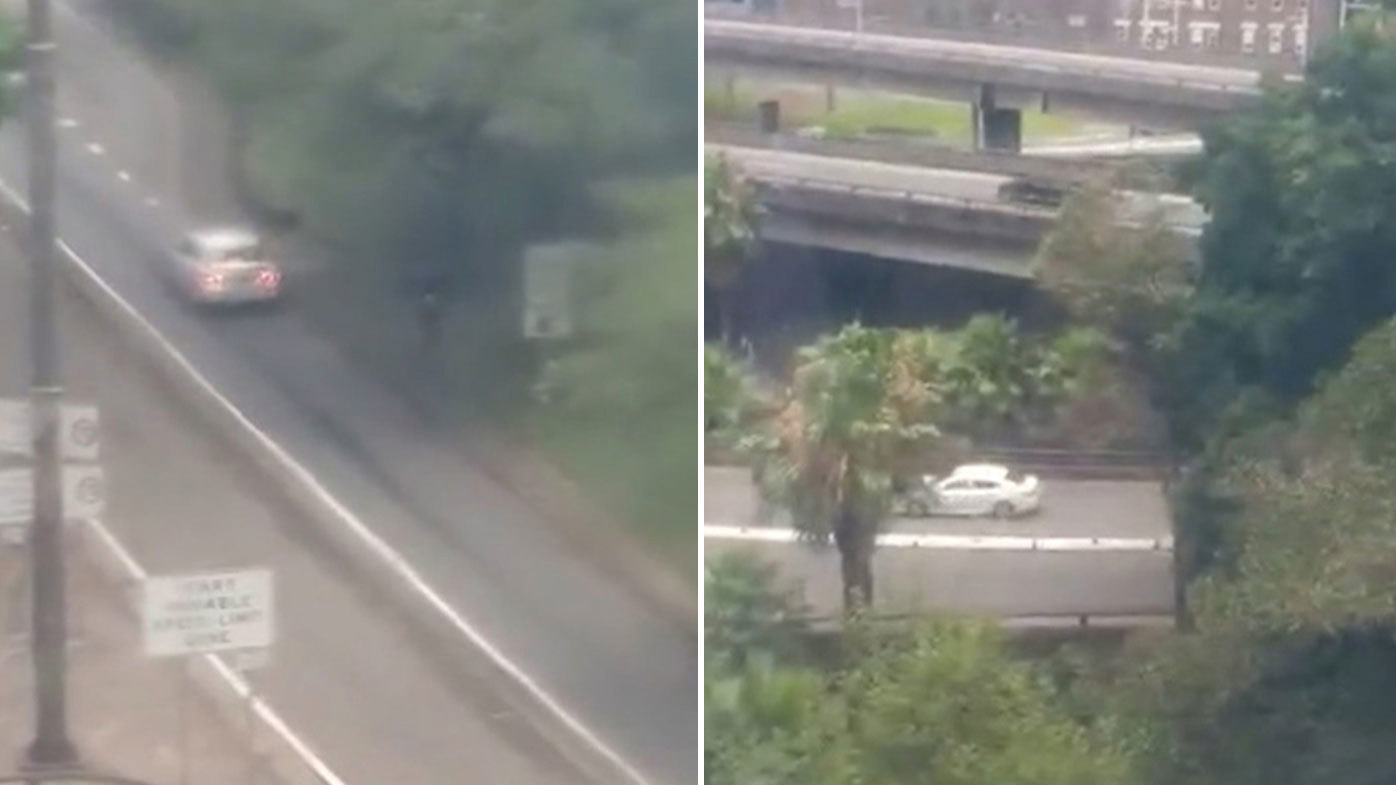 Car filmed reversing up road onto Sydney Harbour Bridge.