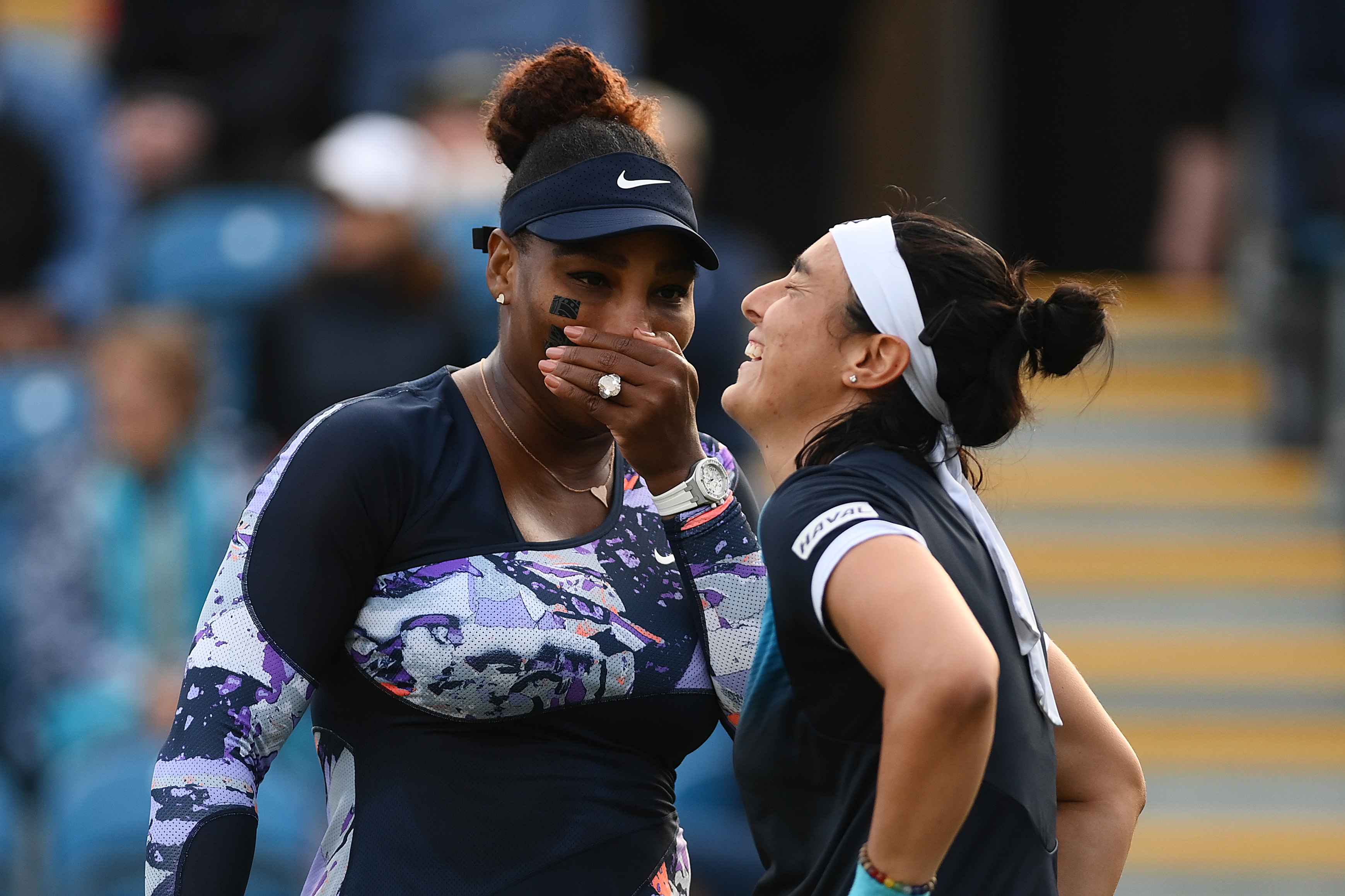 Serena Williams of United States of America and Ons Jabeur of Tunisia interact during their Women's Doubles Round One match against Marie Bouzkova of Czech Republic and Sara Sorribes Tormo of Spain on Day 4 of the Rothesay International at Devonshire Park on June 21, 2022 in Eastbourne, England. (Photo by Mike Hewitt/Getty Images)