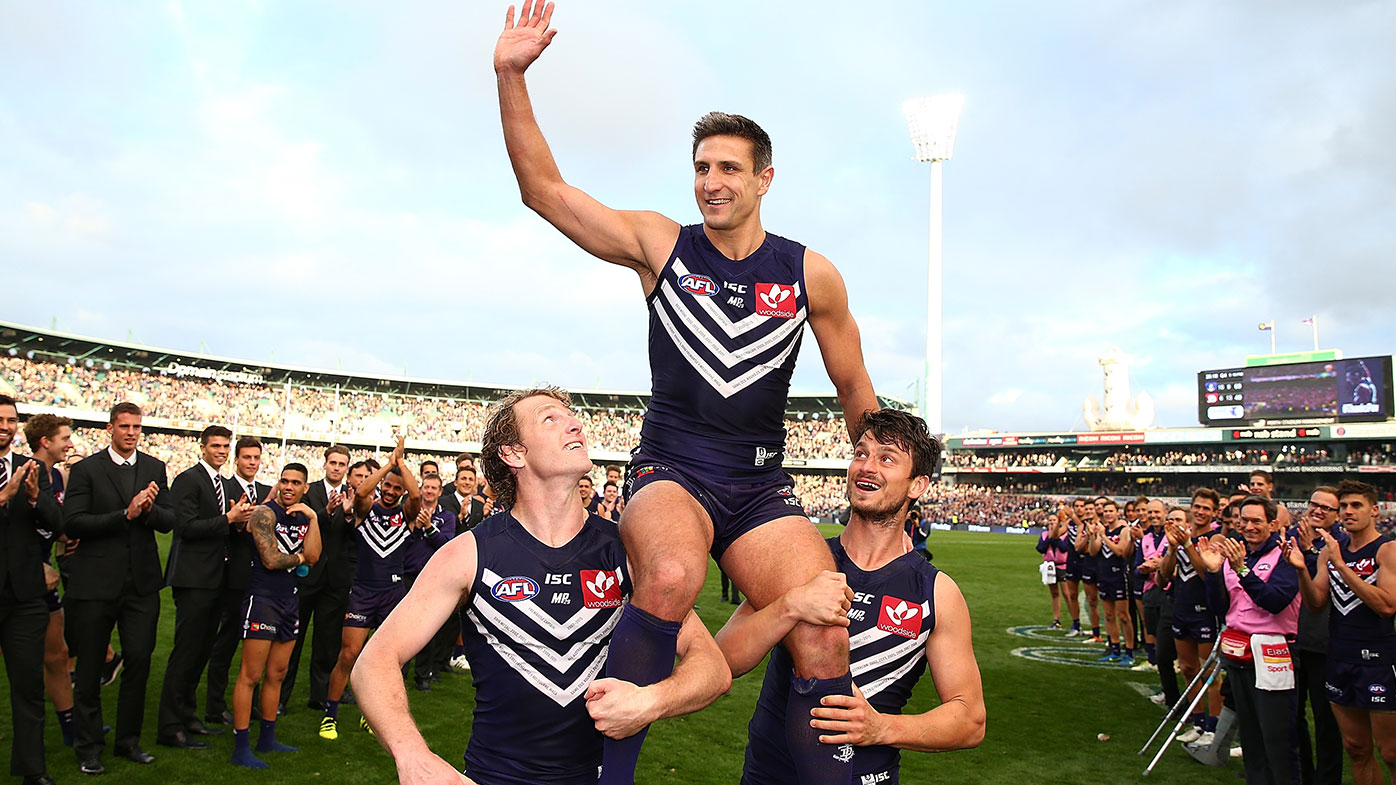 Matthew Pavlich of the Dockers is chaired from the ground by David Mundy and Alex Silvagni after playing his 353rd and final game during the round 23 AFL match between the Fremantle Dockers and the Western Bulldogs at Domain Stadium on August 28, 2016 in Perth, Australia. (Photo by Paul Kane/Getty Images)