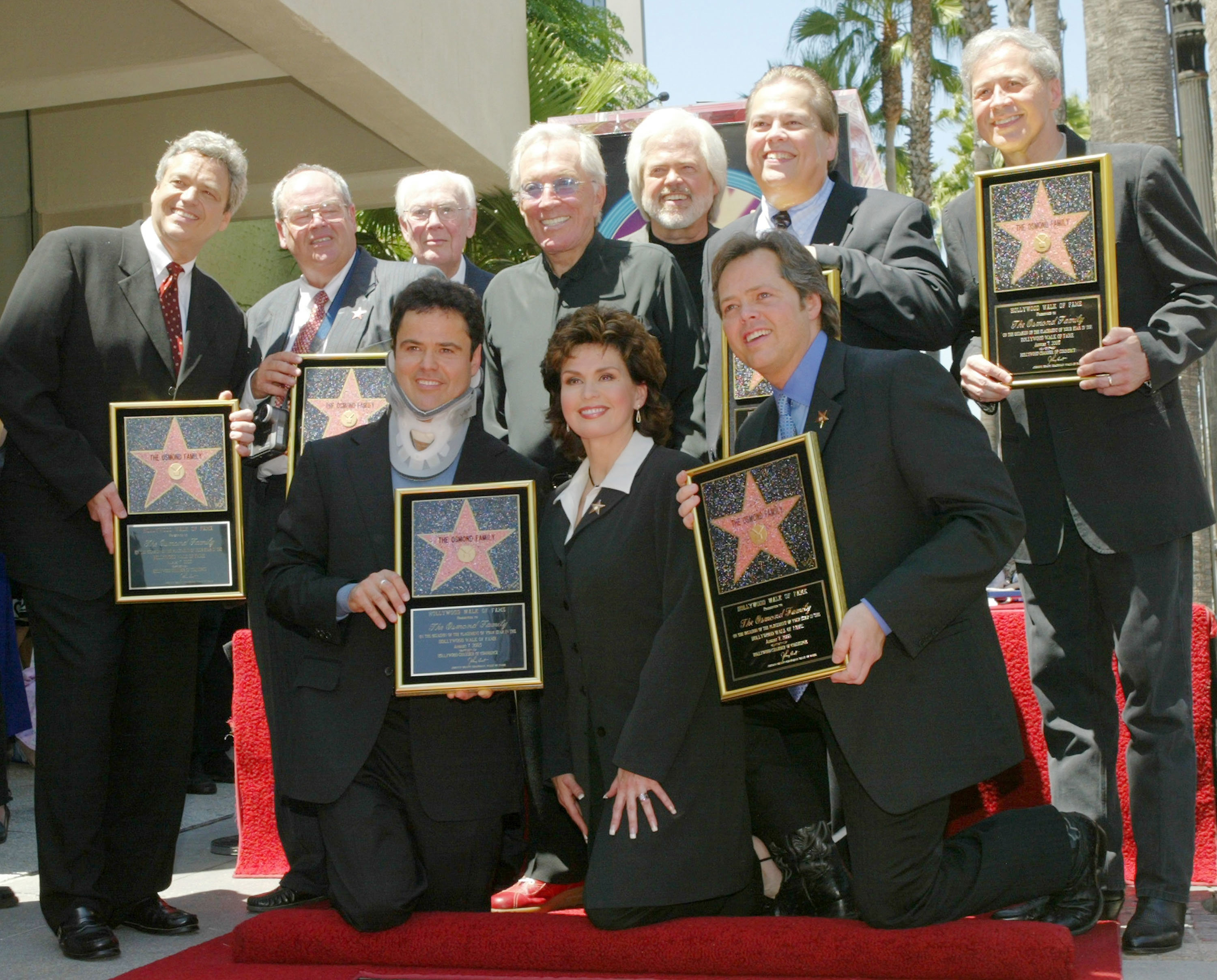 Jay, Tom, family patriarch George, singer Andy Williams, Merrill, Allan and Wayne Osmond.