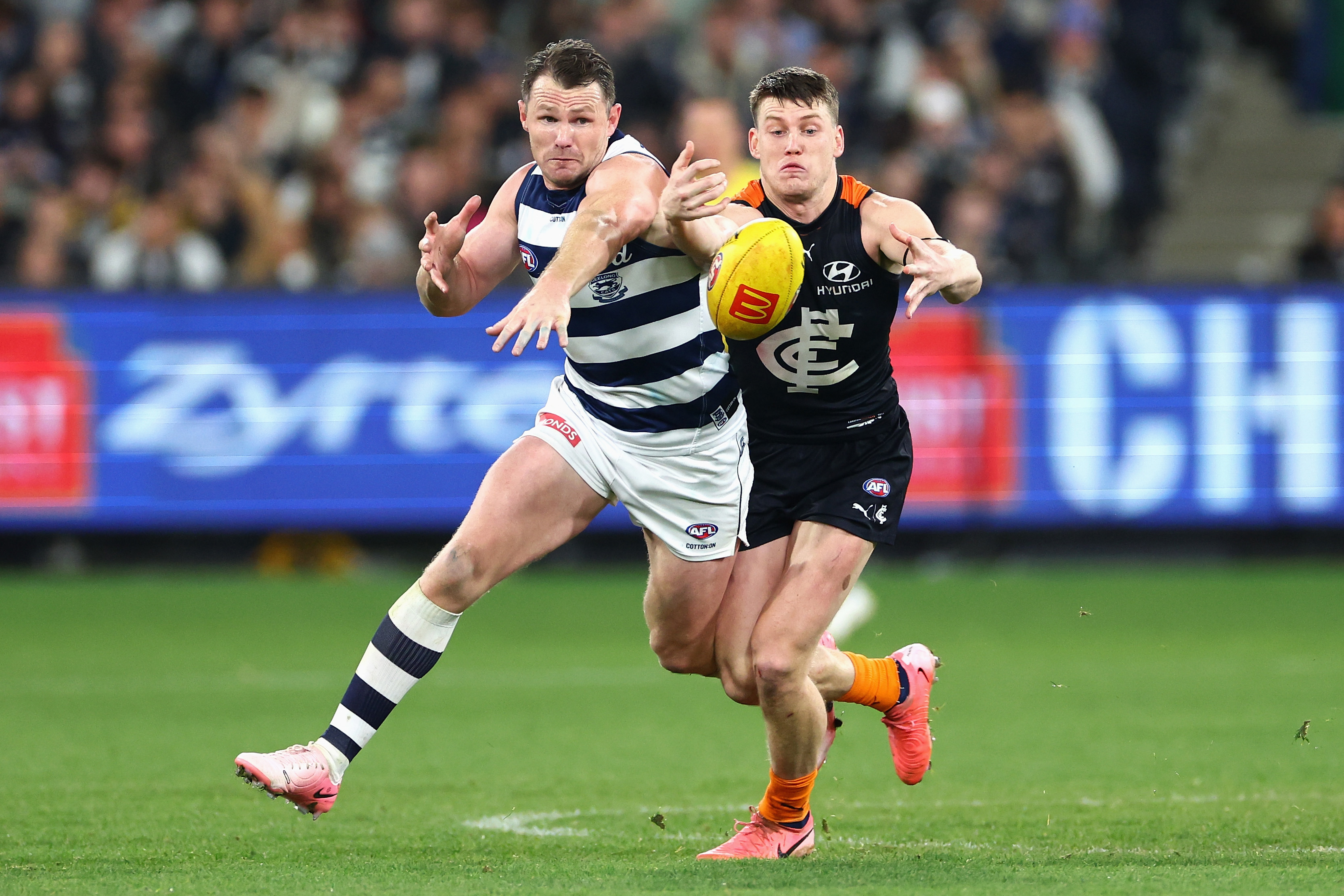 Patrick Dangerfield of Geelong and Sam Walsh of Carlton.