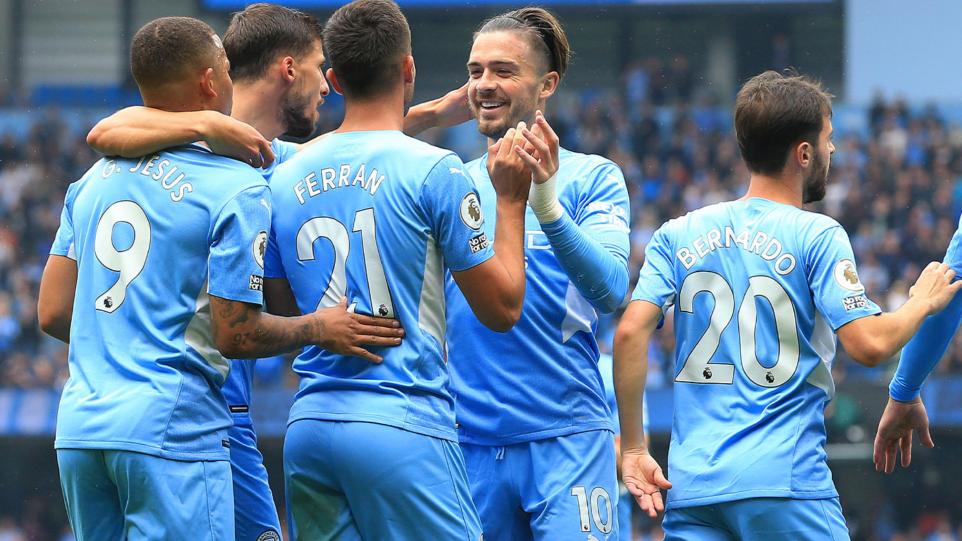  Players of Manchester City celebrate their side's first goal, an own goal by Tim Krul of Norwich City (not pictured) during the Premier League match between Manchester City and Norwich City at Etihad Stadium on August 21, 2021 in Manchester, England. (Photo by Manchester City FC/Manchester City FC via Getty Image