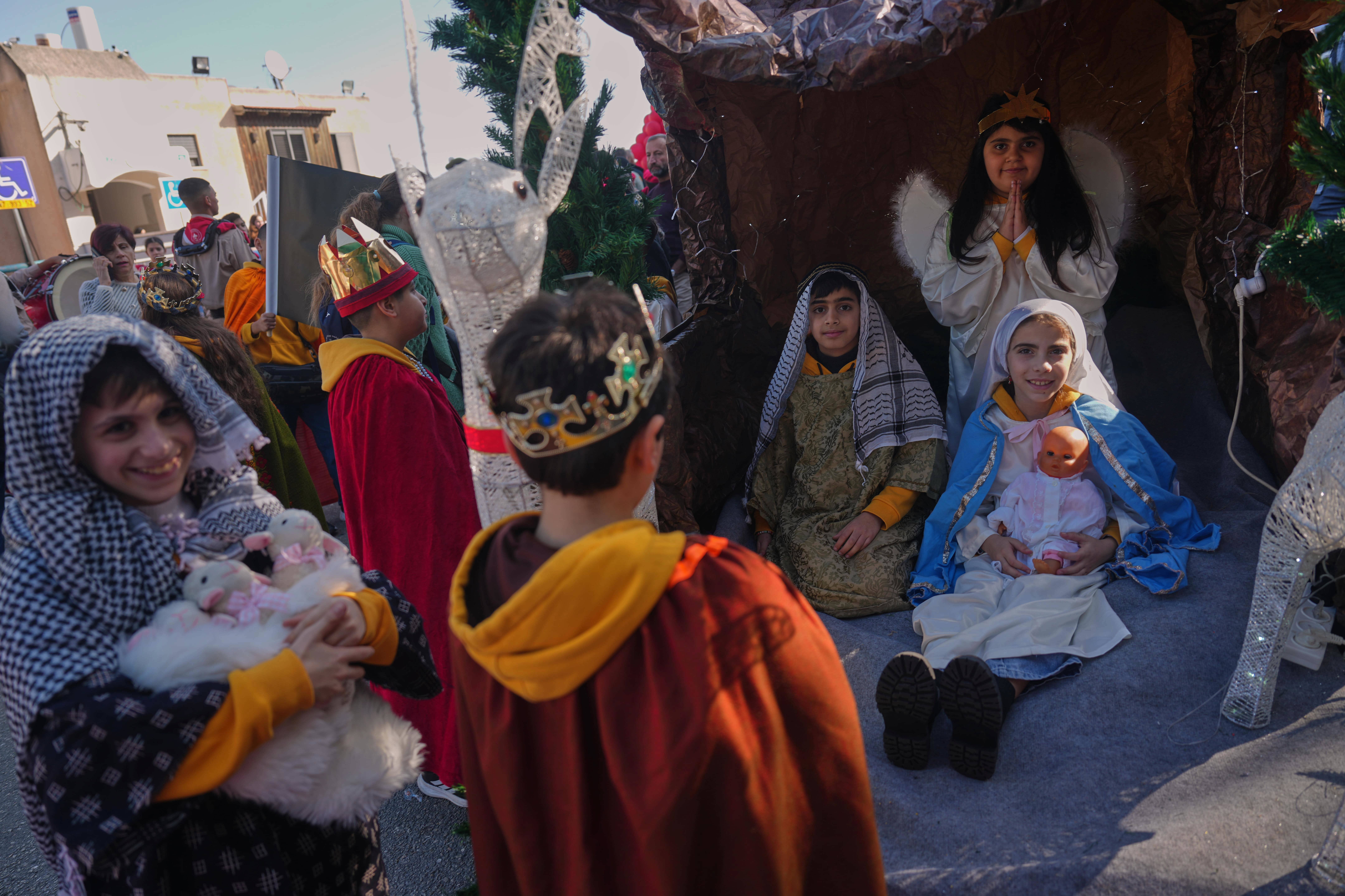 Wearing traditional costumes, children take part in the 40th annual Christmas parade heading towards the Basilica of the Annunciation in Nazareth, Israel.