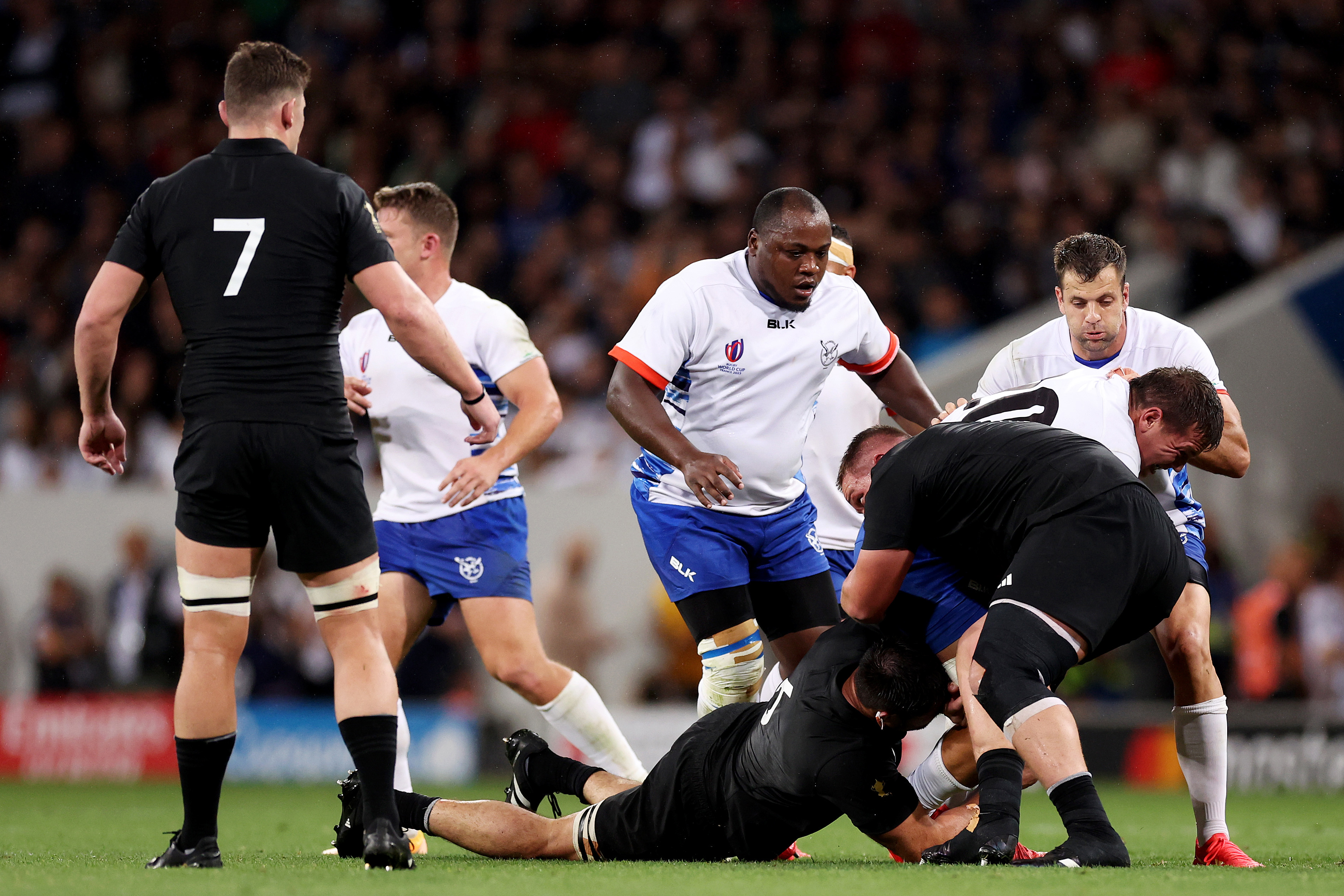 Adriaan Booysen of Namibia is tackled by Ethan de Groot of New Zealand, which later results in a red card for de Groot after the eight-minute TMO bunker review escalates the initial yellow card decision.