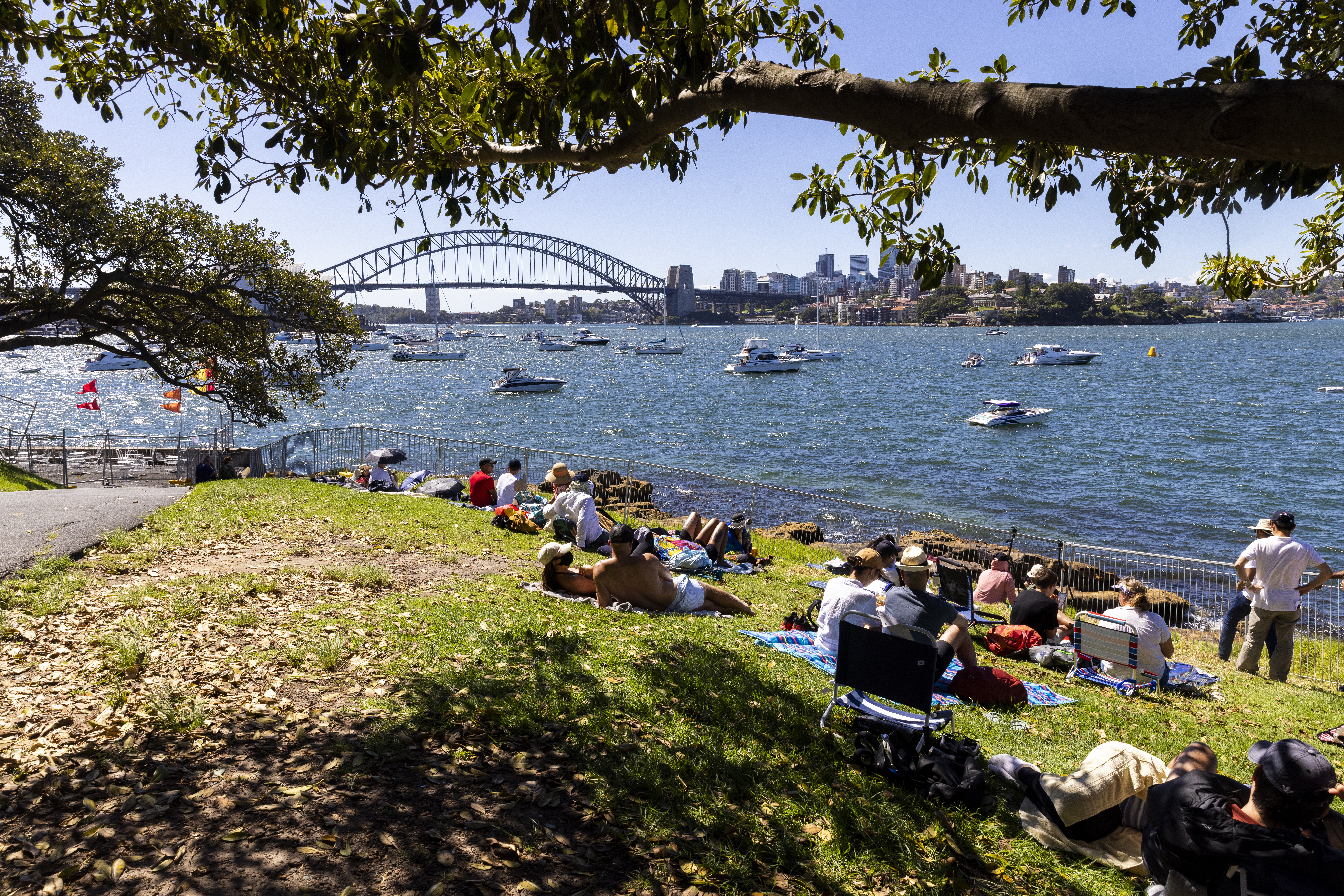 SYDNEY, AUSTRALIA - DECEMBER 31: A small group of people are seen at Mrs Macquaries Point with limited numbers during New Year's Eve celebrations on December 31, 2021 in Sydney, Australia. New Year's Eve celebrations continue to be somewhat different as some COVID-19 restrictions remain in place due to the ongoing coronavirus pandemic. (Photo by Jenny Evans/Getty Images)