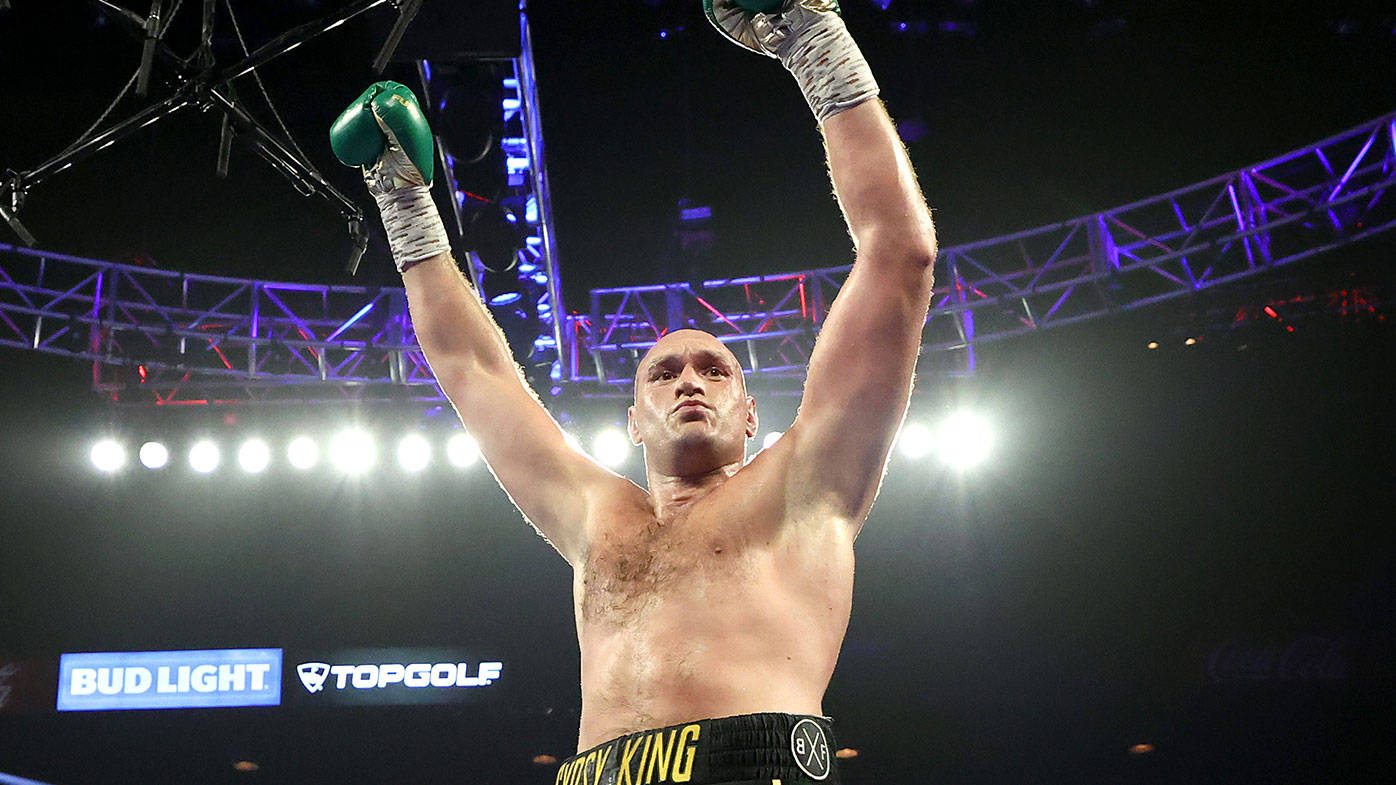 Tyson Fury celebrates after knocking down Deontay Wilder during their Heavyweight bout for Wilder's WBC and Fury's lineal heavyweight title