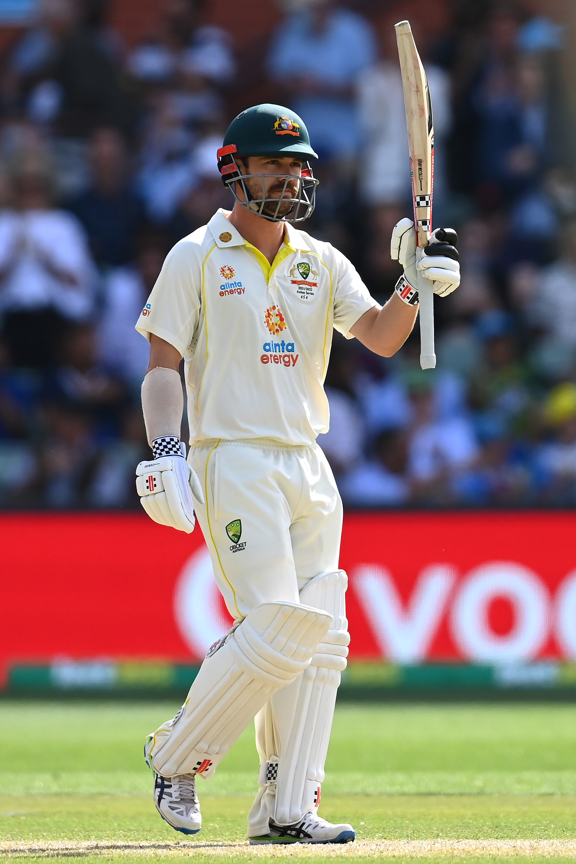Travis Head of Australia celebrates scoring a half century.