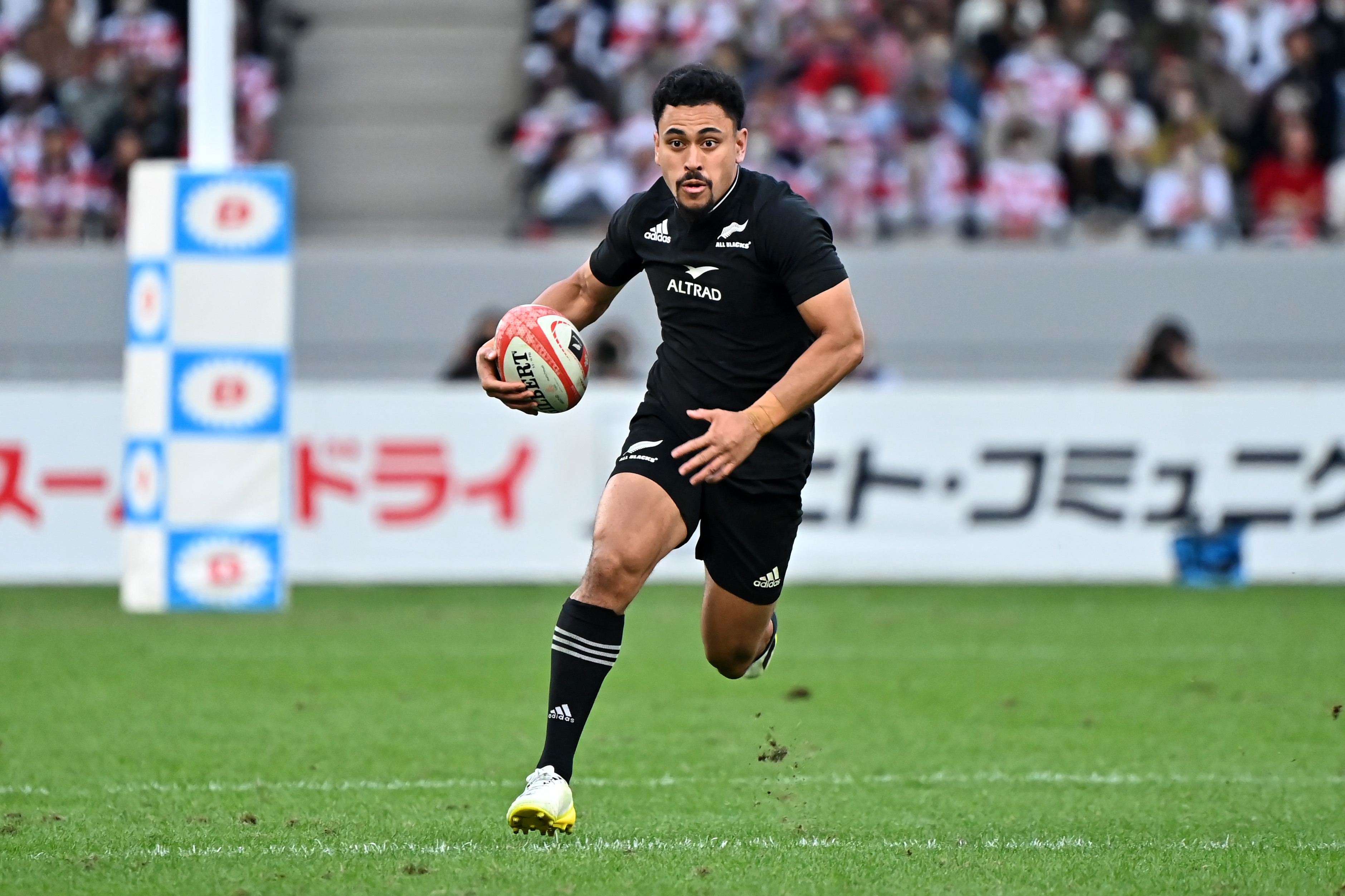 Stephen Perofeta of New Zealand runs with the ball.