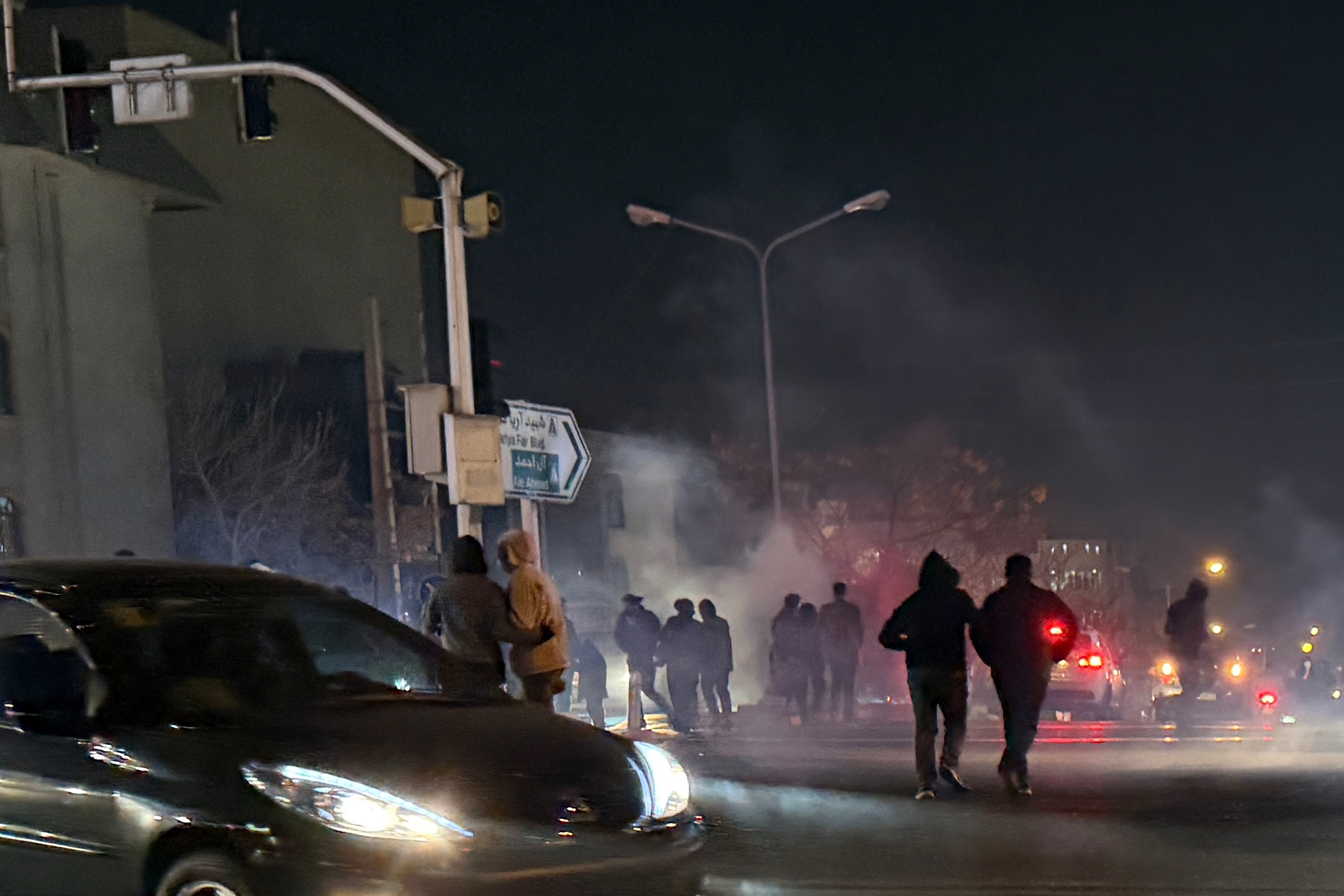 In this photo obtained by The Associated Press, tear gas is fired during an anti-government protest in Tehran, Iran, Thursday, Jan. 8, 2026. (UGC via AP)