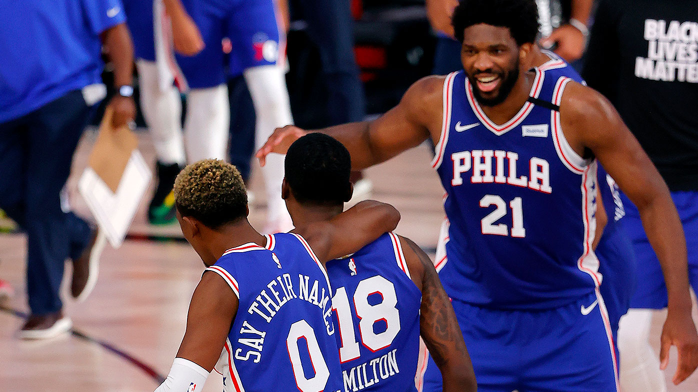 Shake Milton #18 of the Philadelphia 76ers is congratulated by his teammates, Joel Embiid #21 and Josh Richardson #0,