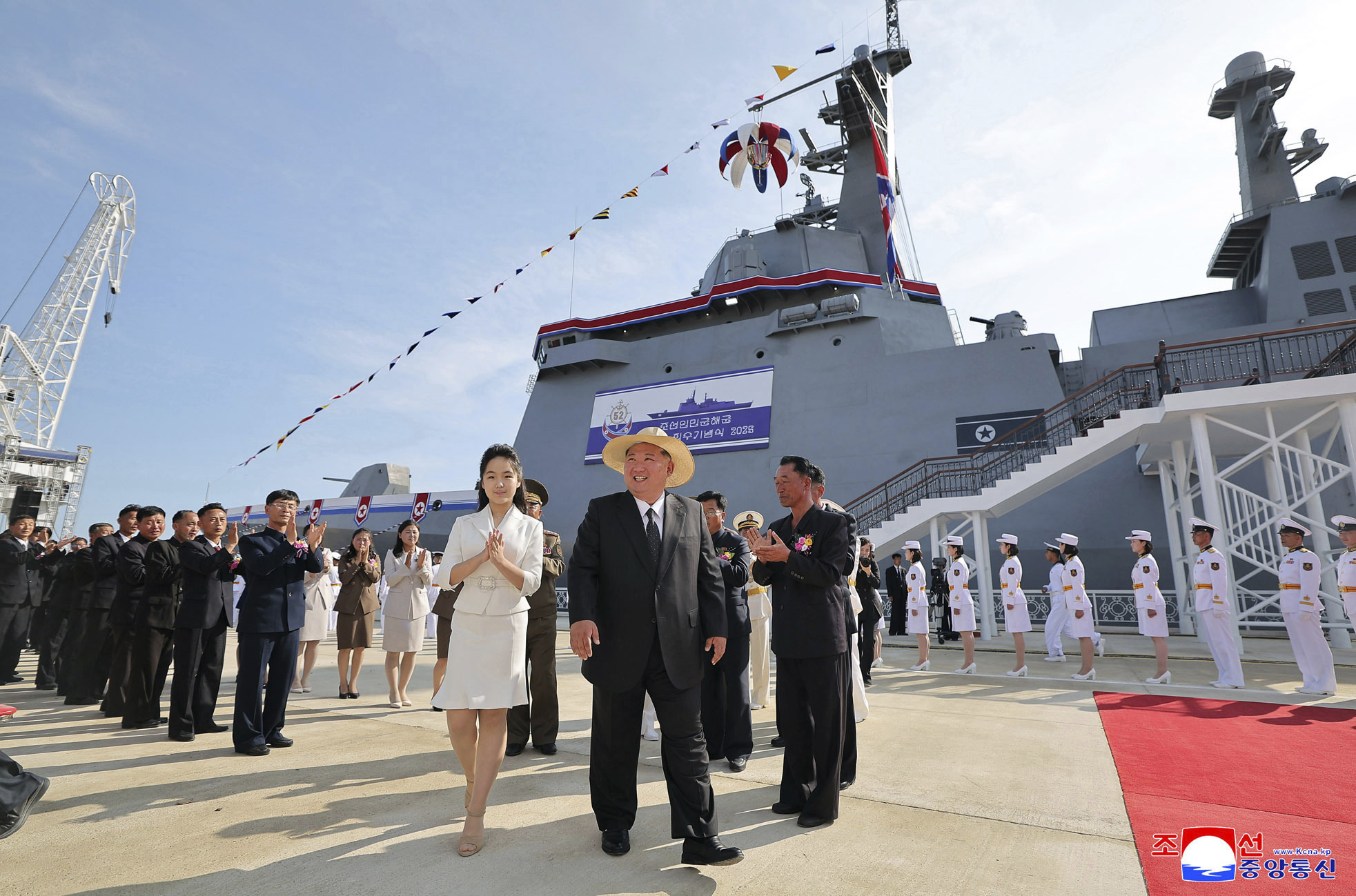 In this photo provided by the North Korean government, its leader Kim Jong Un, center, and his daughter attend a launch ceremony of a destroyer named Kang Kon at the Rajin shipyard in Rason, North Korea, Thursday, June 12, 2025.