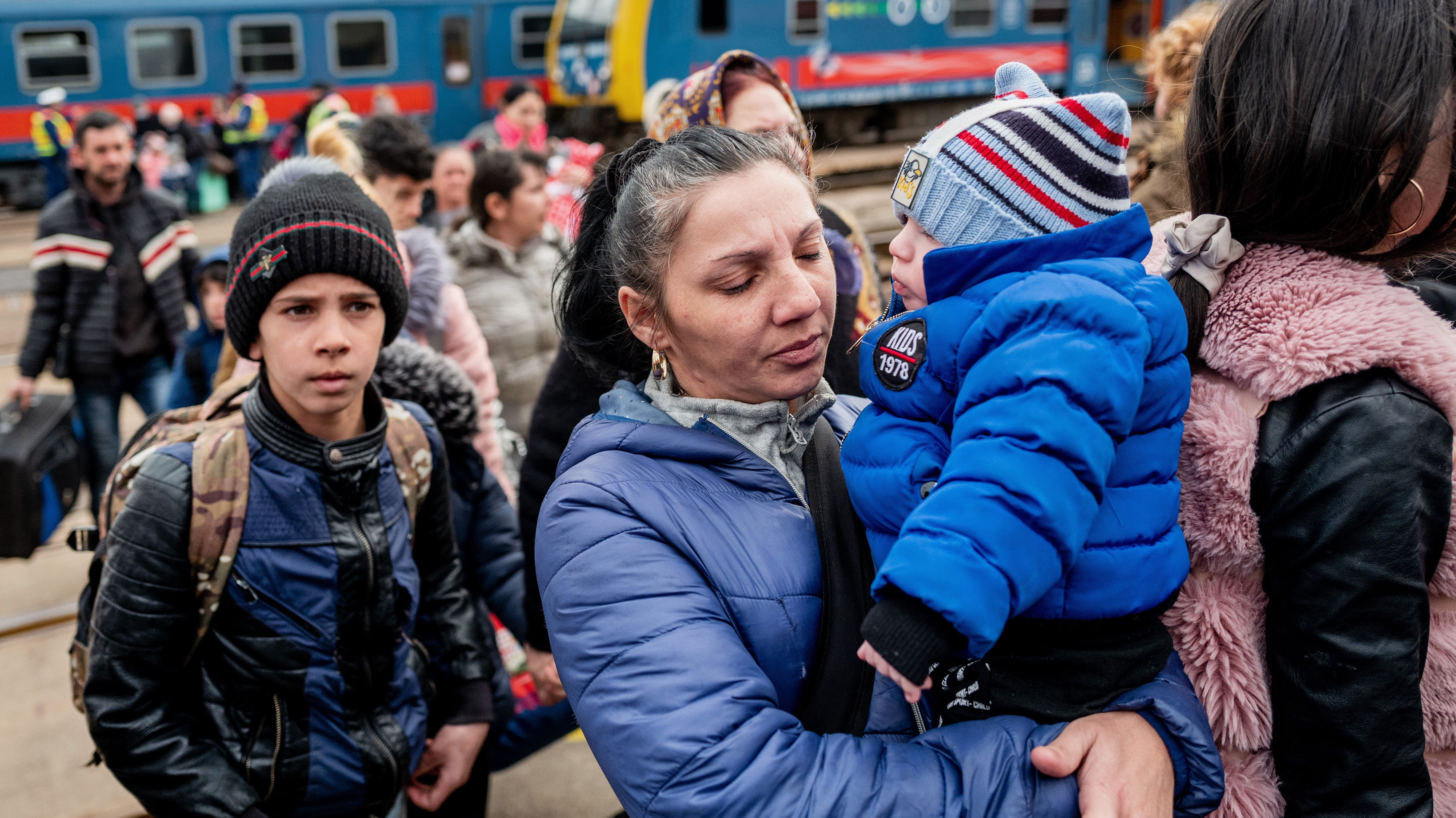 People arrive at the train station after crossing the border at Zahony-Csap in Zahony, Hungary. 