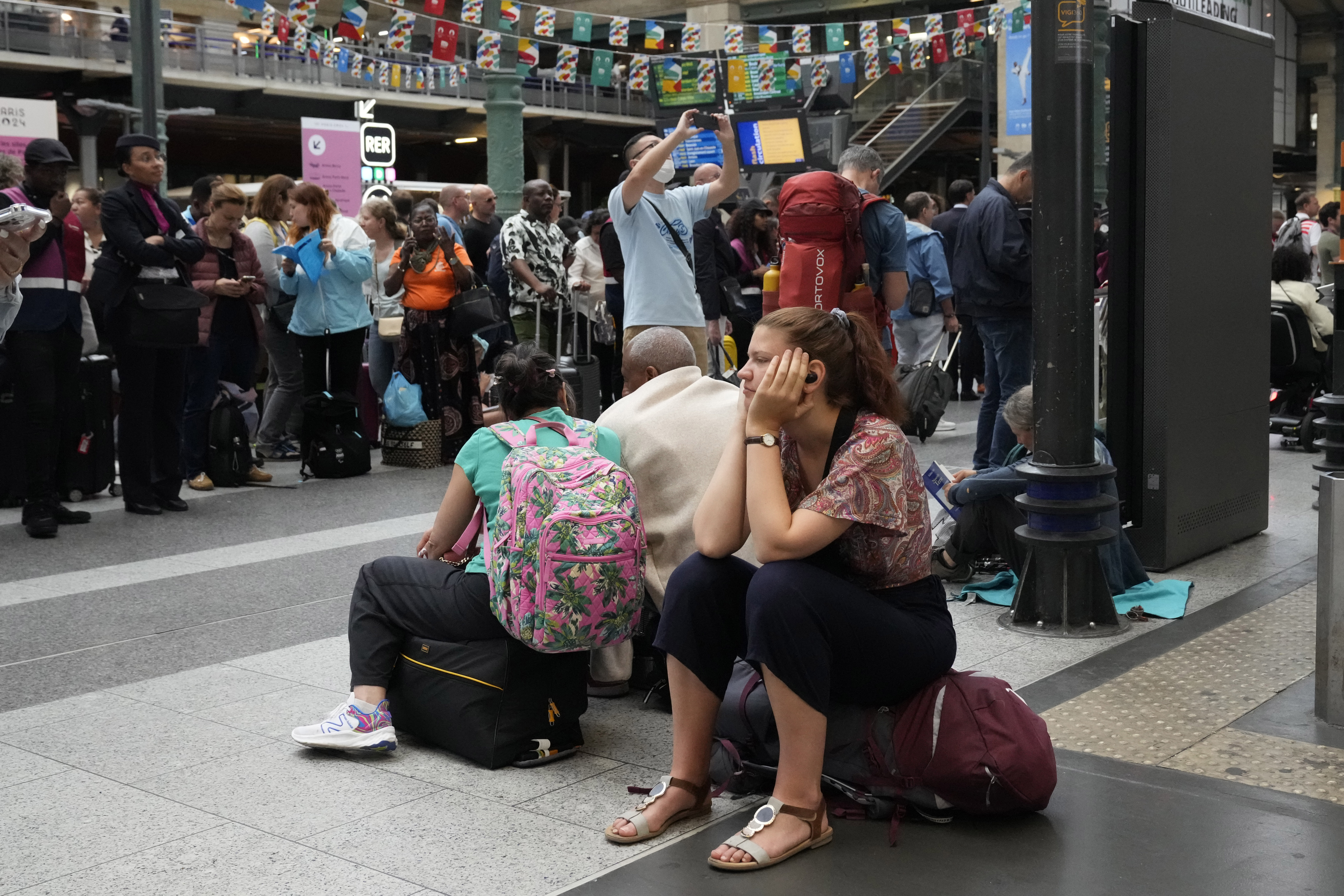 A traveller waits inside the Gare du Nord train station at the 2024 Summer Olympics, Friday, July 26, 2024, in Paris, France. 