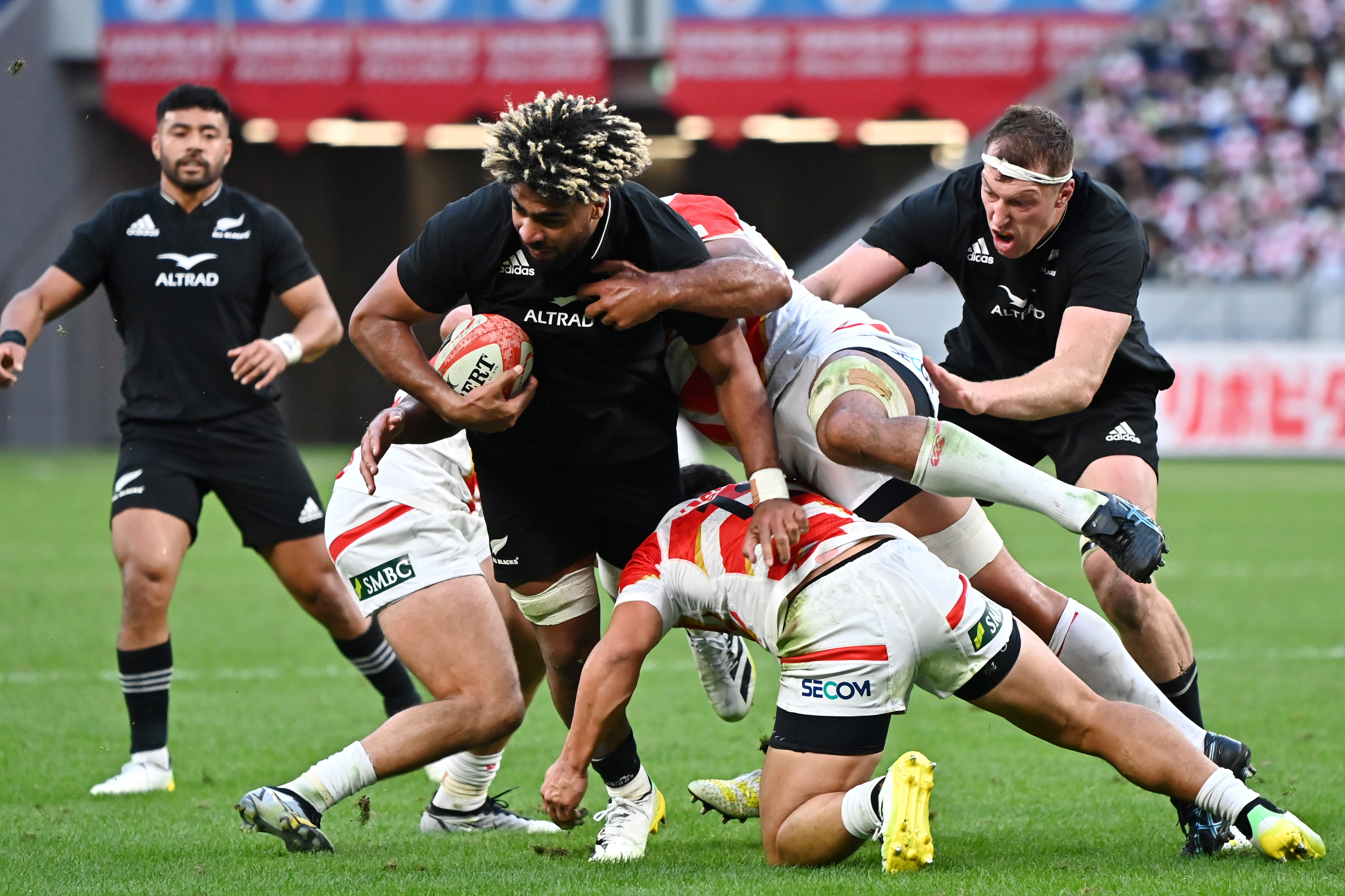 Hoskins Sotutu of New Zealand is tackled at National Stadium in Tokyo.