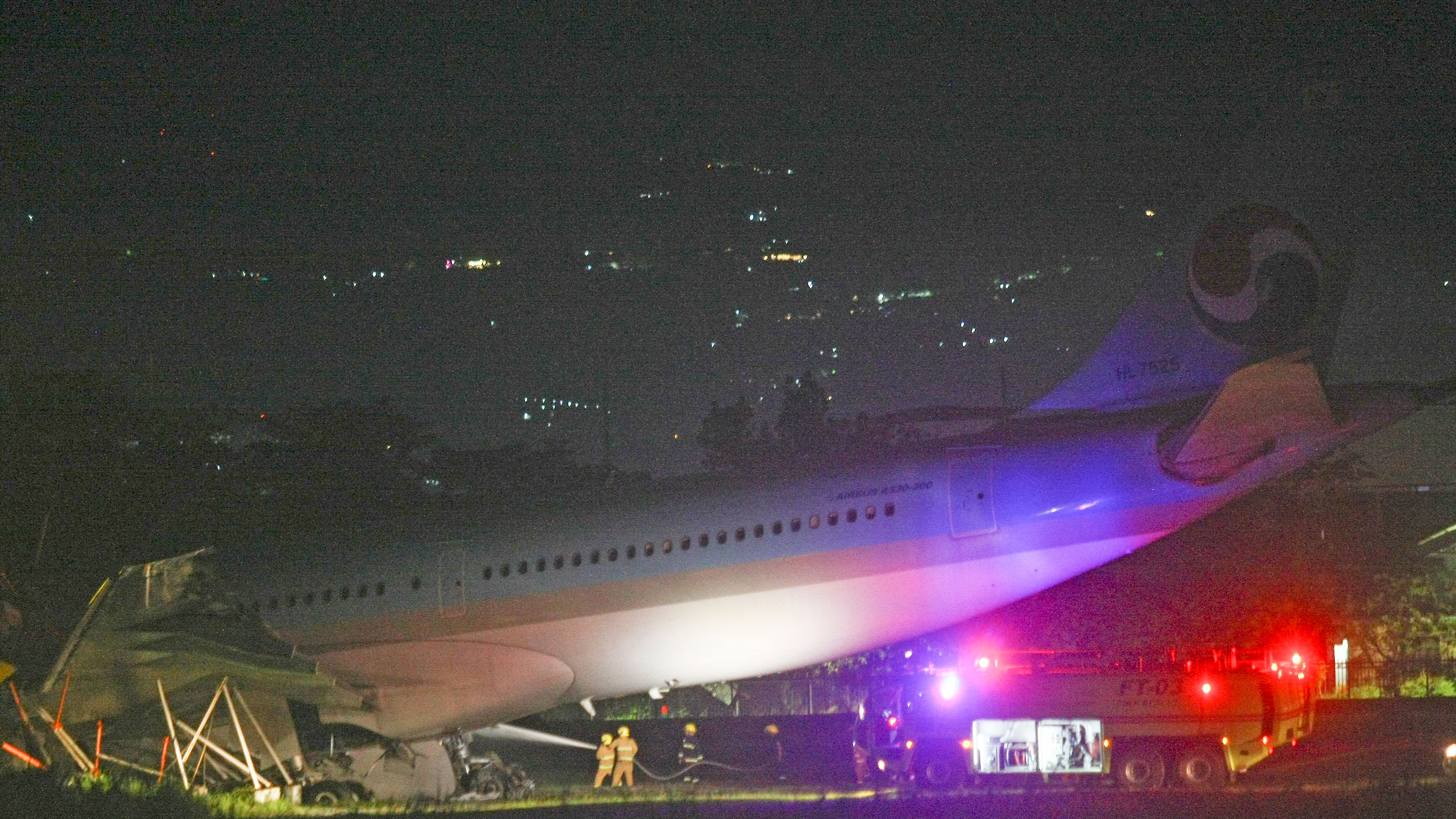 Firefighters train their hoses on a Korean Air Lines Co. plane after it overshot the runway at the Mactan-Cebu International Airport in Cebu, central Philippines.