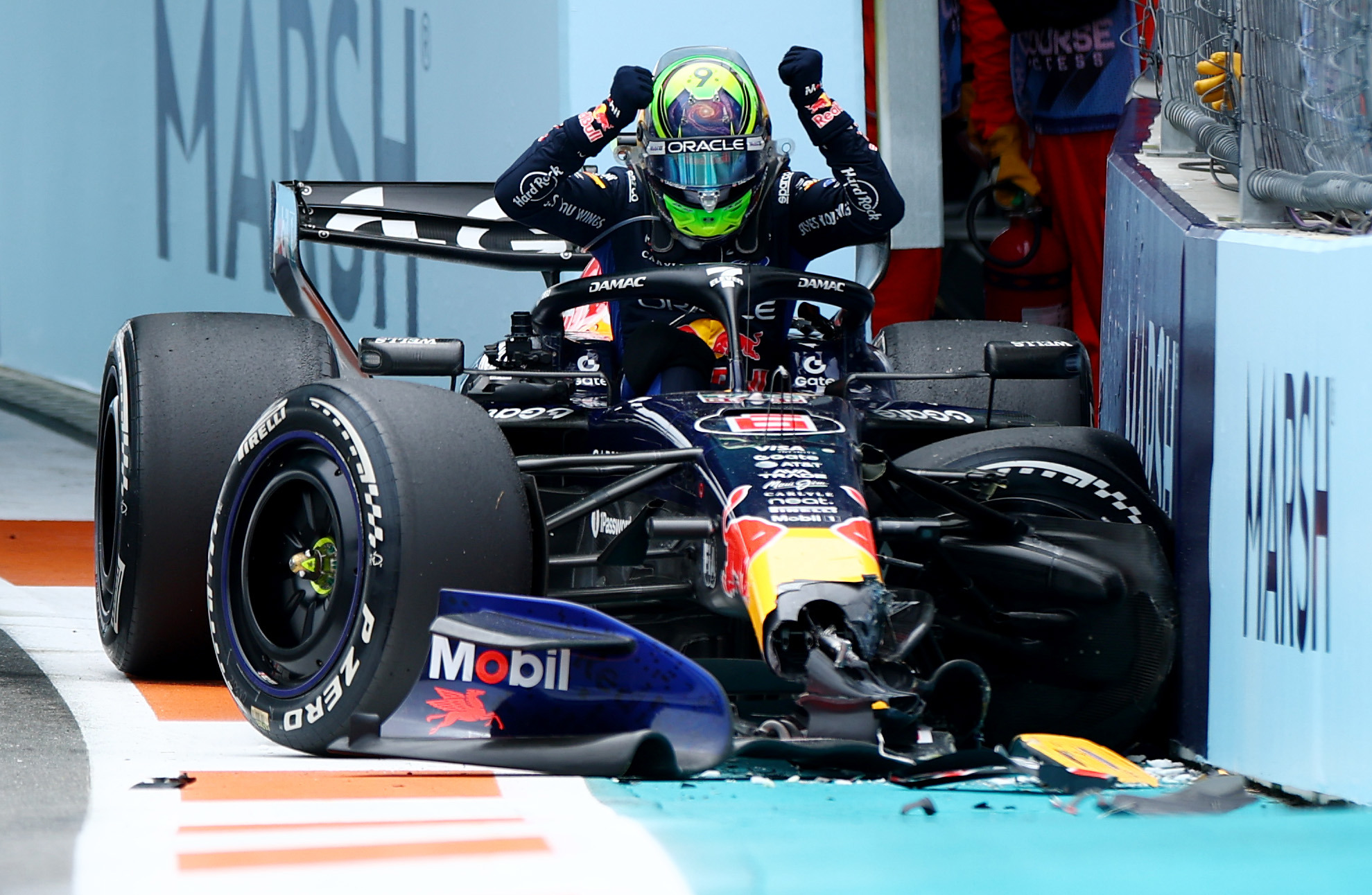 Isack Hadjar slams his fists on his Red Bull car after an untimely crash. 