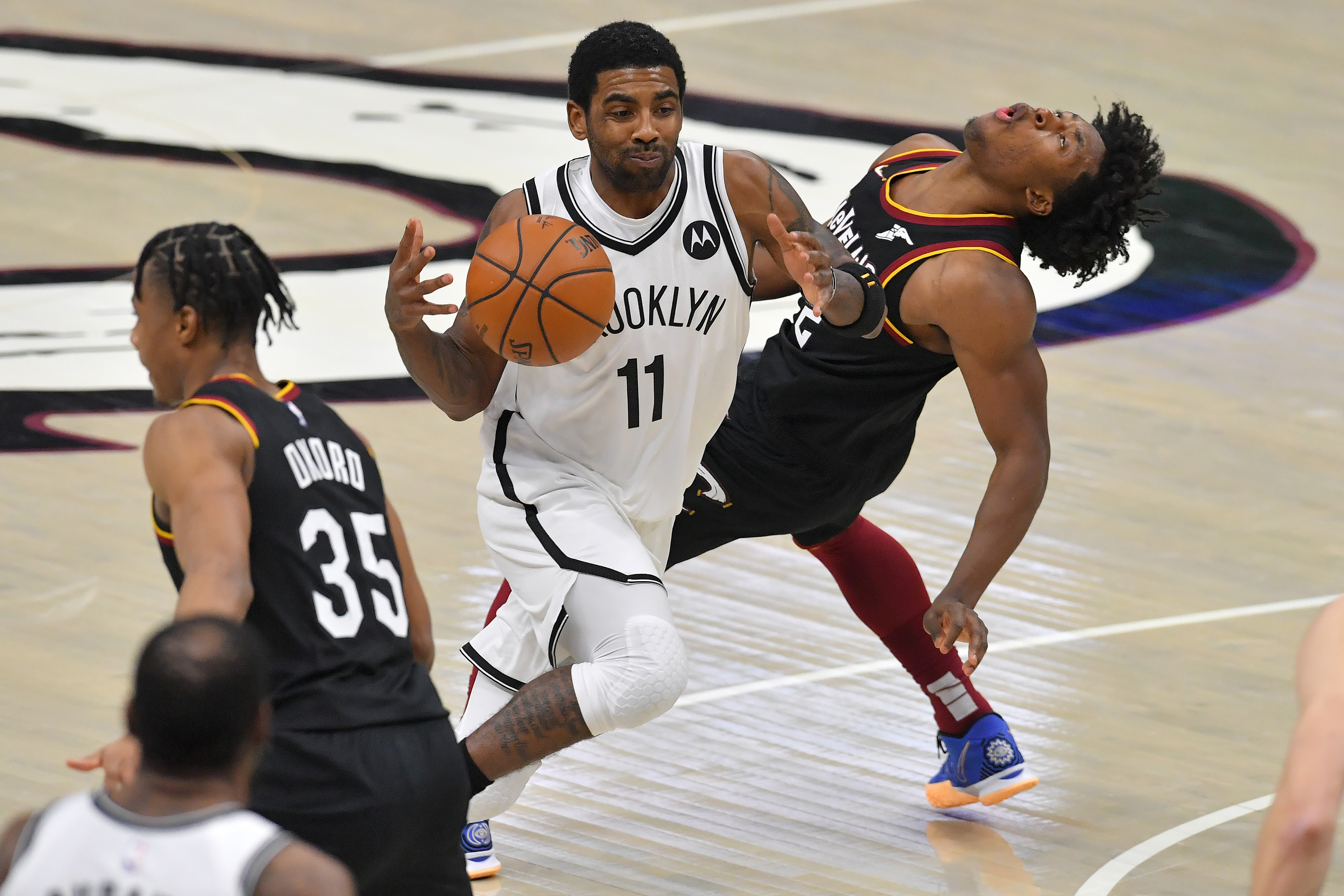 Kyrie Irving of the Brooklyn Nets runs into Collin Sexton of the Cleveland Cavaliers.