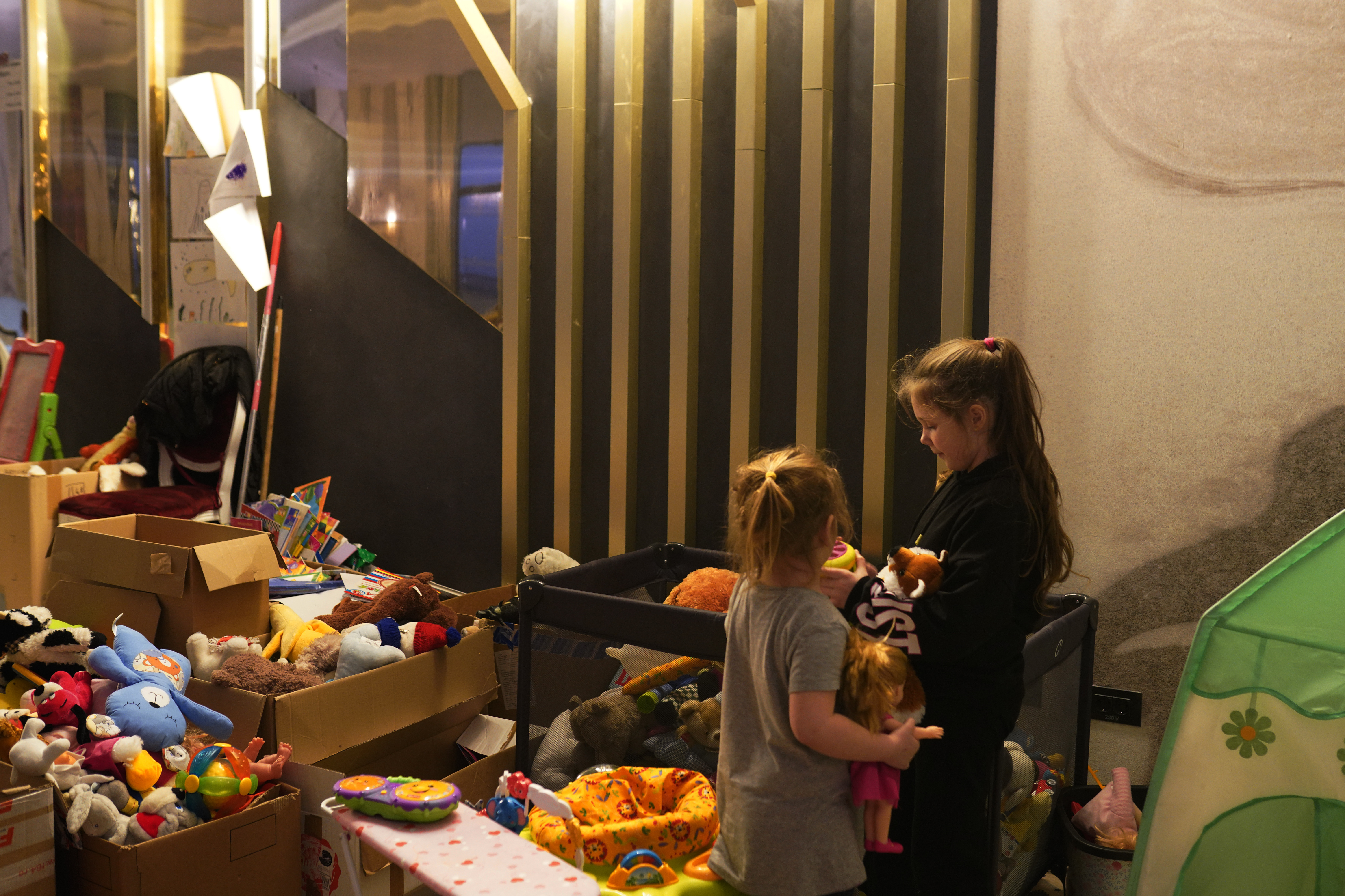 SUCEAVA, ROMANIA - [MARCH 18]: Girls who fled the conflict in Ukraine play with donated toys in the ballroom in Mandachi Hotel and Spa, that was turned into a temporary shelter, on March 18, 2022 in Suceava, Romania. Ukrainian refugees continue to cross the border into Romania since Russia's invasion on February 24, some 500,000 Ukrainian citizens have entered Romania, with the majority reportedly making their way onto other countries in Western Europe.  (Photo by Andreea Campeanu/Getty Images)