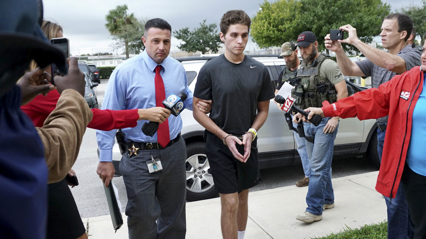 Austin Harrouff is transported by detectives to the Martin County Jail from St. Mary's Hospital in Florida in 2016.
