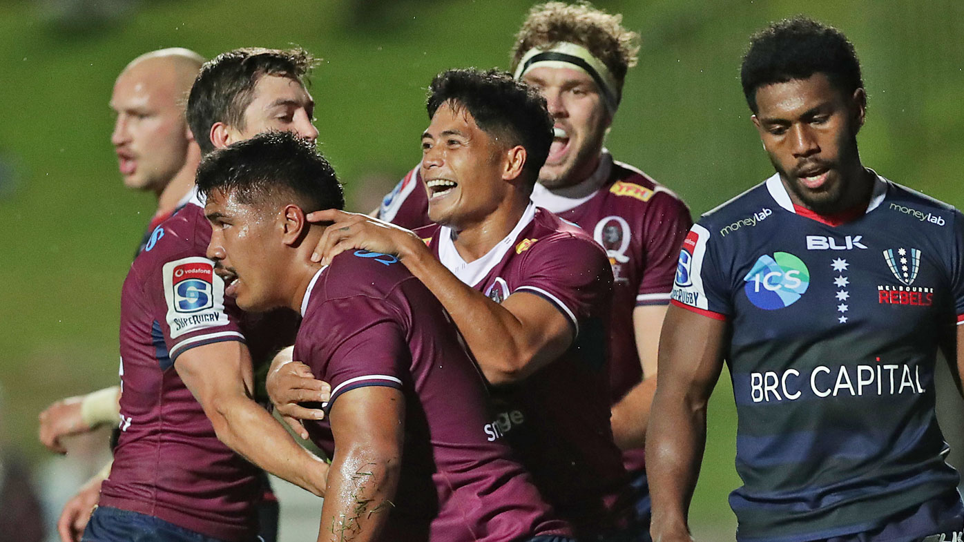 Alex Mafi of the Reds celebrates scoring a try 