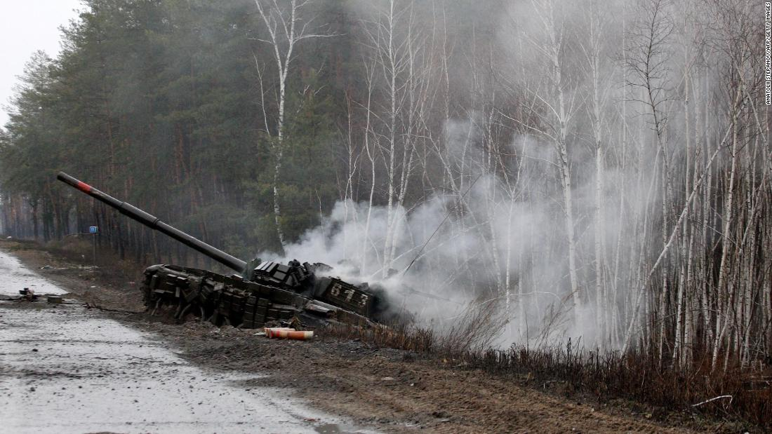 Smoke rises from a destroyed Russian tank on the side of a road in the Lugansk region of Ukraine. 