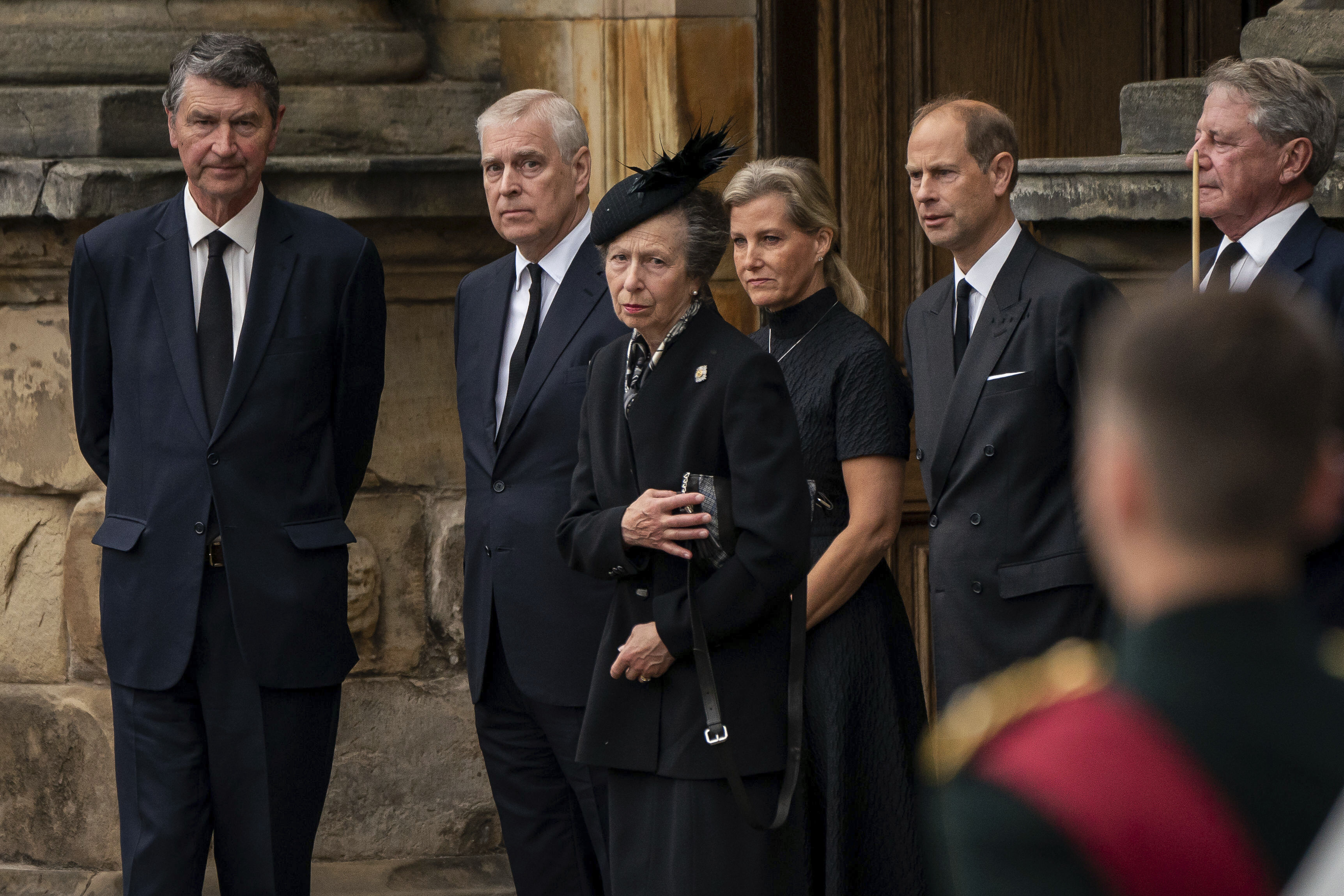 From left, Vice Admiral Timothy Laurence, Prince Andrew, Princess Anne, Sophie the Countess of Wessex and Prince Edward watch as the coffin of Queen Elizabeth II, draped with the Royal Standard of Scotland, completes its journey from Balmoral to the Palace of Holyroodhouse, where it will lie in rest for a day,  in Edinburgh, Sunday, Sept. 11, 2022. Queen Elizabeth II, Britain's longest-reigning monarch and a rock of stability across much of a turbulent century, died Thursday Sept. 8, 2022, after