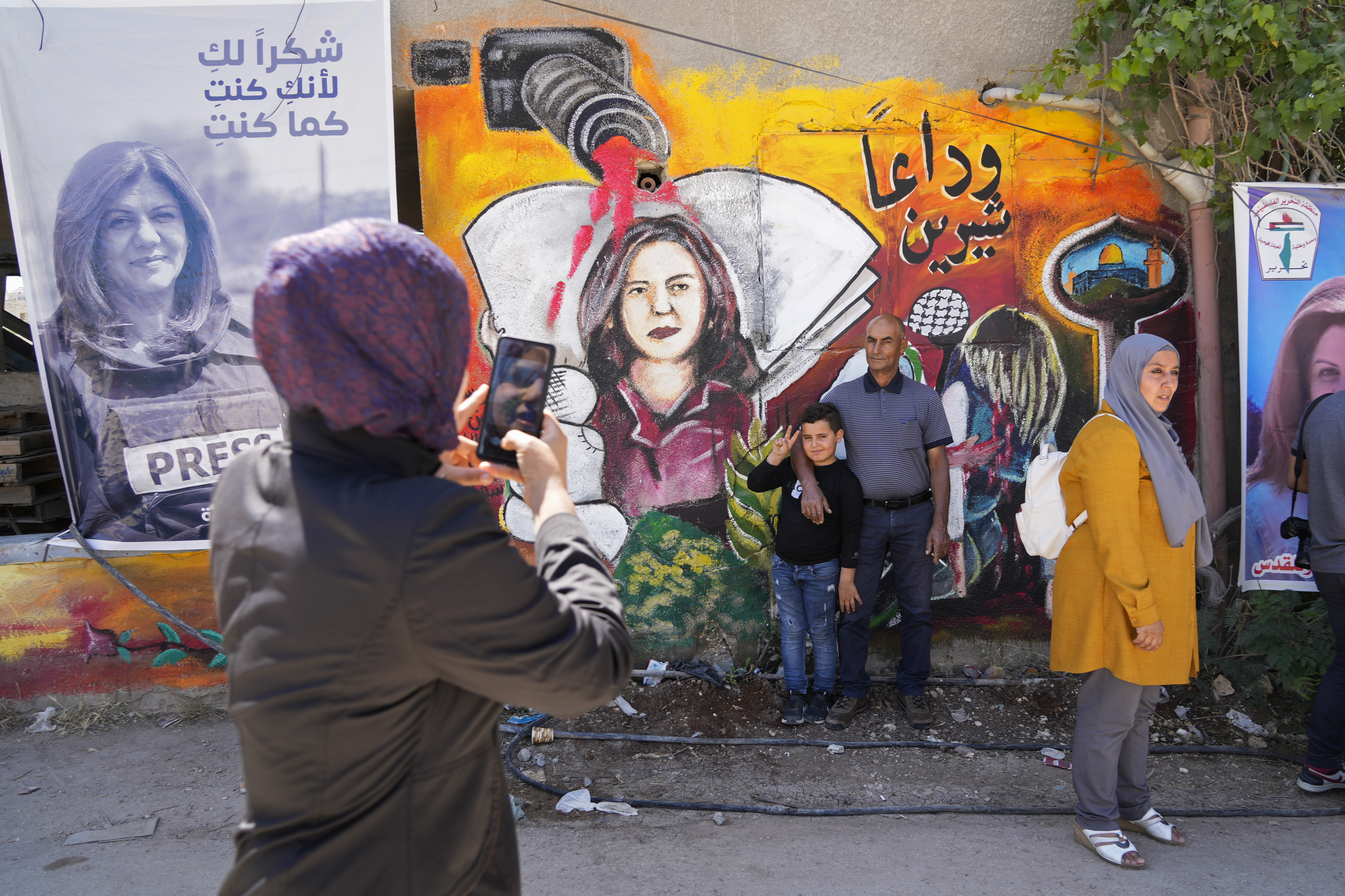 Palestinians visit the site where veteran Palestinian-American reporter Shireen Abu Akleh was shot and killed, in the West Bank city of Jenin, May 18, 2022.  The Al Jazeera news network says it will submit a case file to the International Criminal Court on the killing of reporter Shireen Abu Akleh, who was shot dead earlier this month during an Israeli raid in the occupied West Bank. (AP Photo/Majdi Mohammed, File)