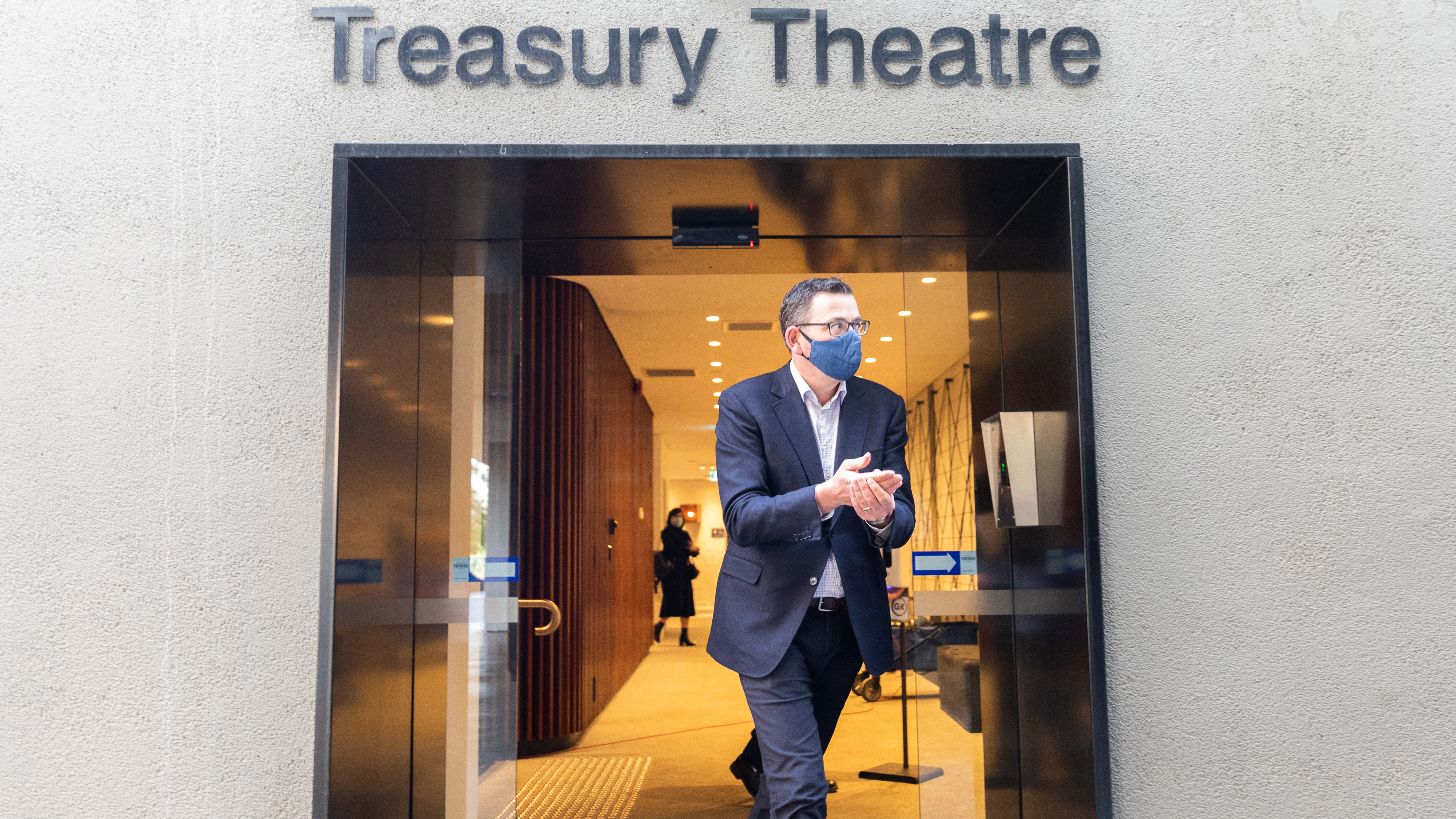 Premier of Victoria Daniel Andrews wearing a mask walks out of the theatre hall after his press conference on July 24, 2020 in Melbourne.