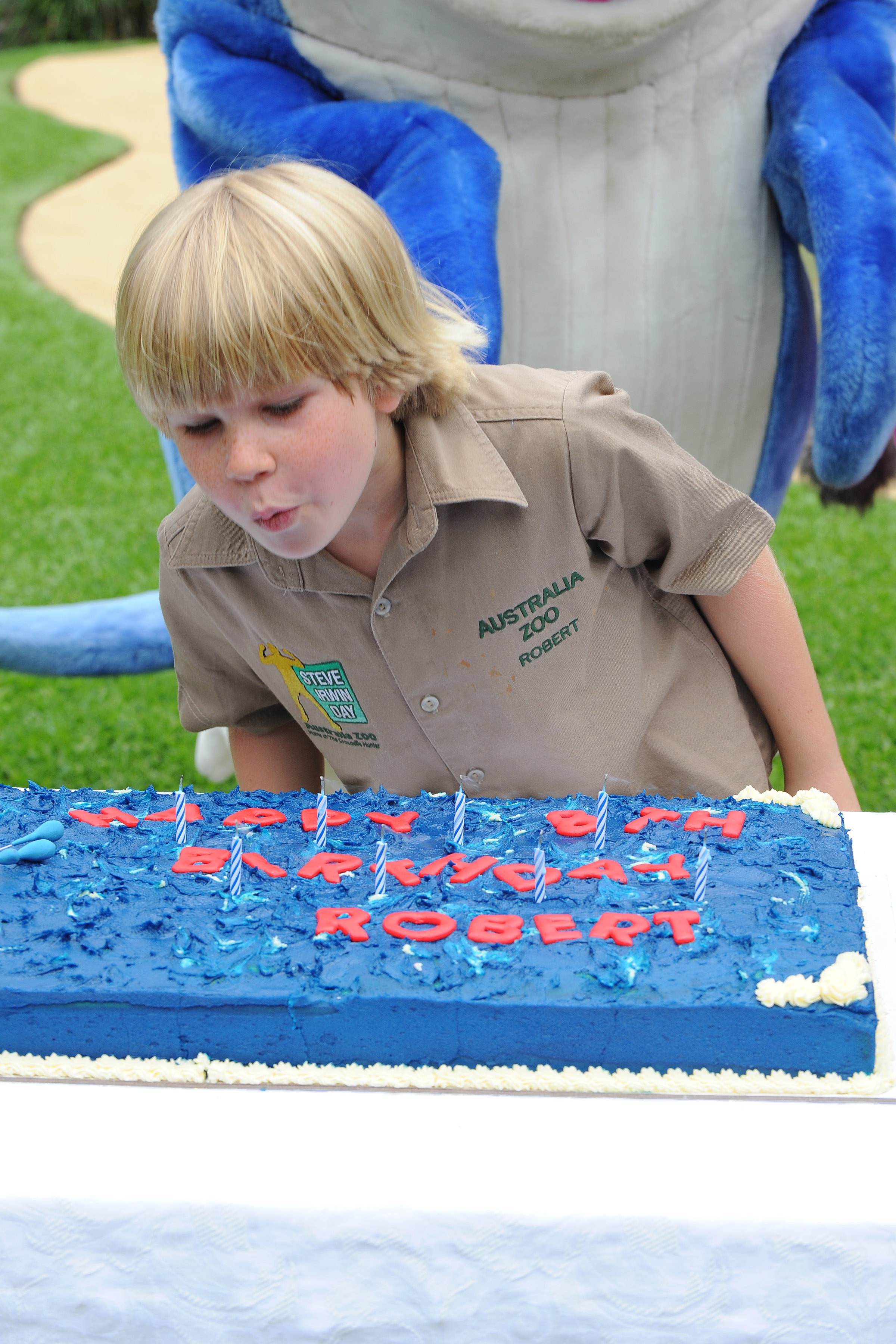 BEERWAH, AUSTRALIA - DECEMBER 1: In this handout photo provided by Australia Zoo, Robert Irwin blows out the candles on his cake as he celebrates his eighth birthday, at Australia Zoo, on December 1, 2011 in Beerwah, Australia. (Photo by Australia Zoo via Getty Images)