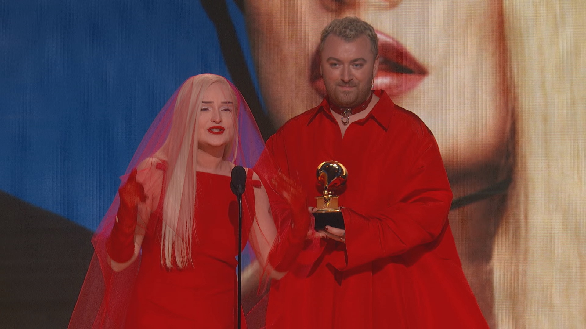 Kim Petras and Sam Smith accept Grammy award during 2023 ceremony.