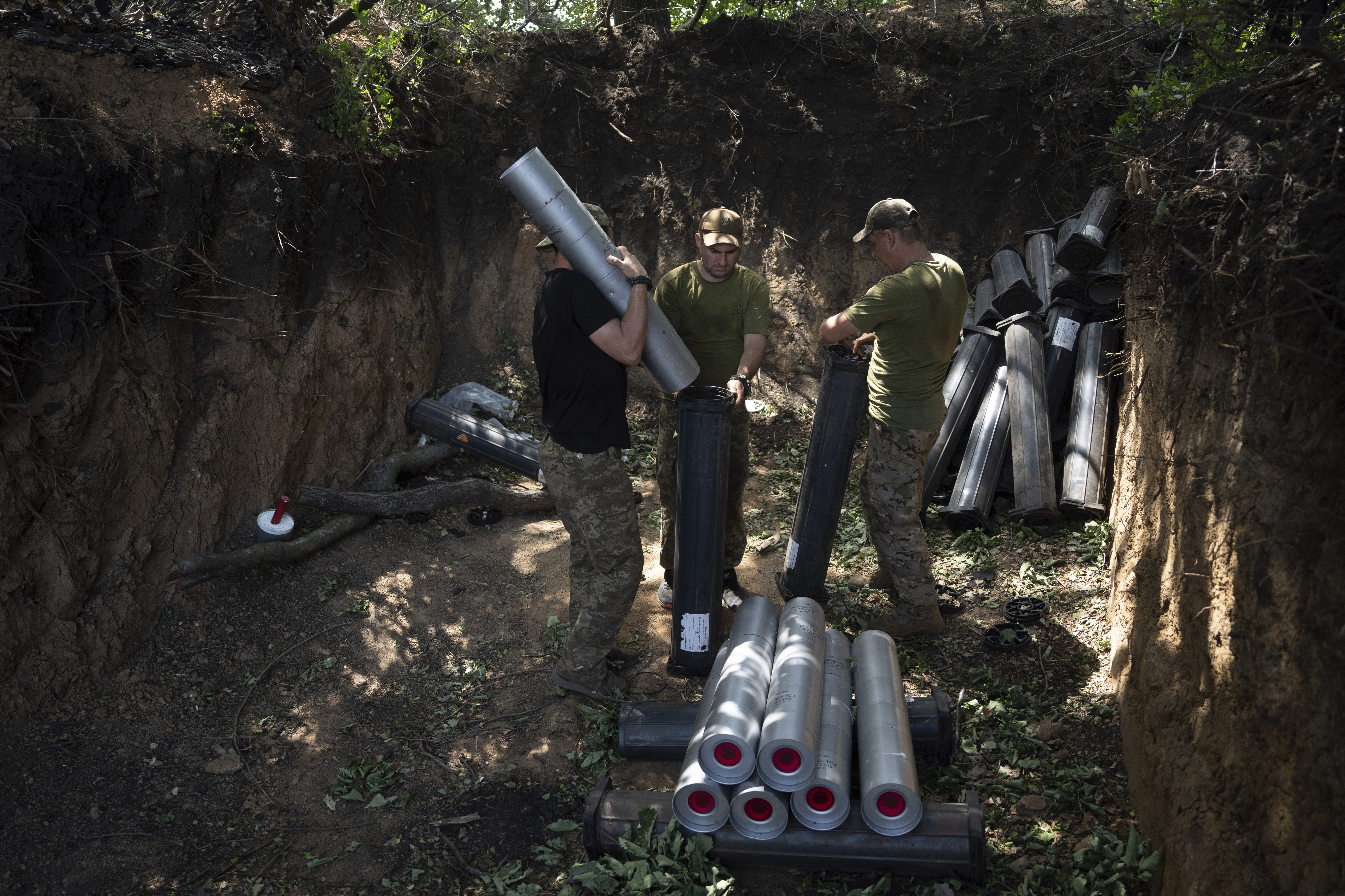 Ukrainian servicemen prepare ammunition for self-propelled howitzer "Bohdana" before firing towards Russian positions near Bakhmut, Ukraine, Friday, July 7, 2023.